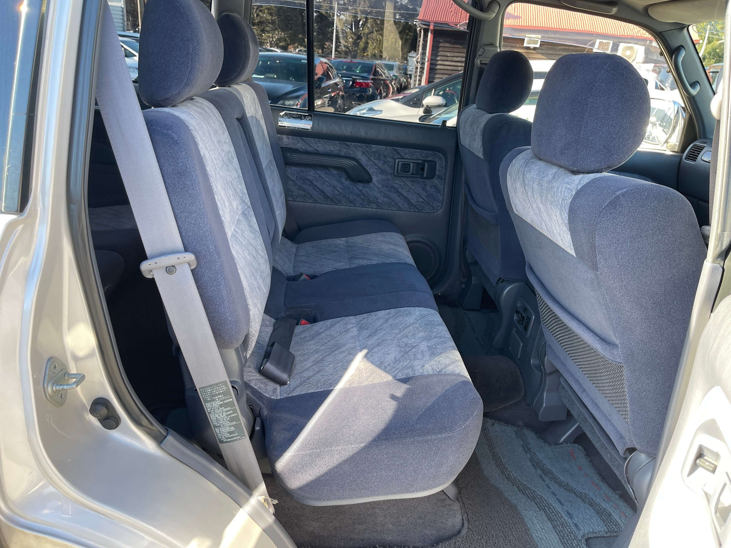 Interior view of the back seats in a 1996 Toyota Land Cruiser Prado V6 3.4L TZ, featuring 8-seat configuration.