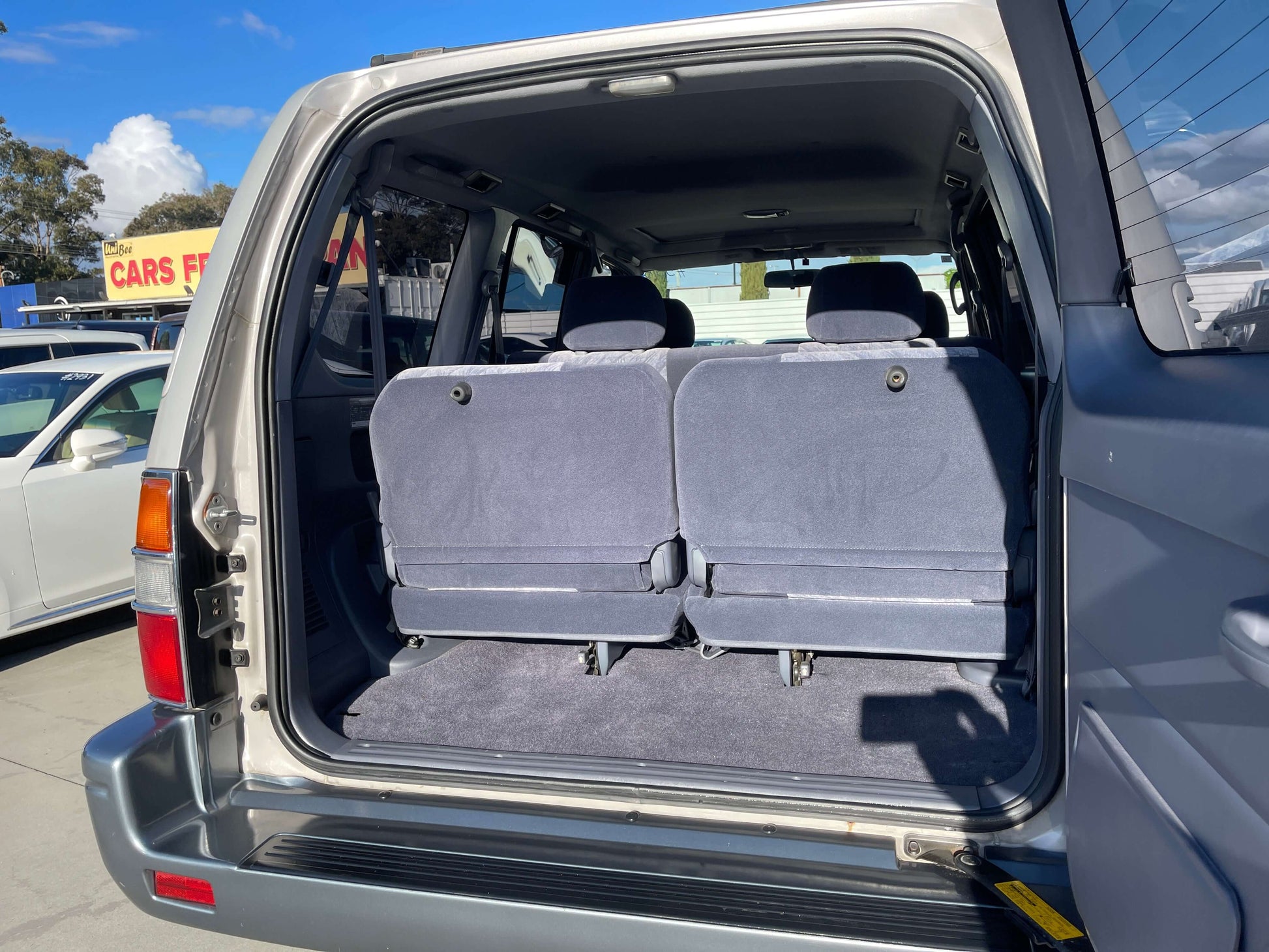 Interior view of the back seats in a 1996 Toyota Land Cruiser Prado V6 3.4L, featuring 8 seats.