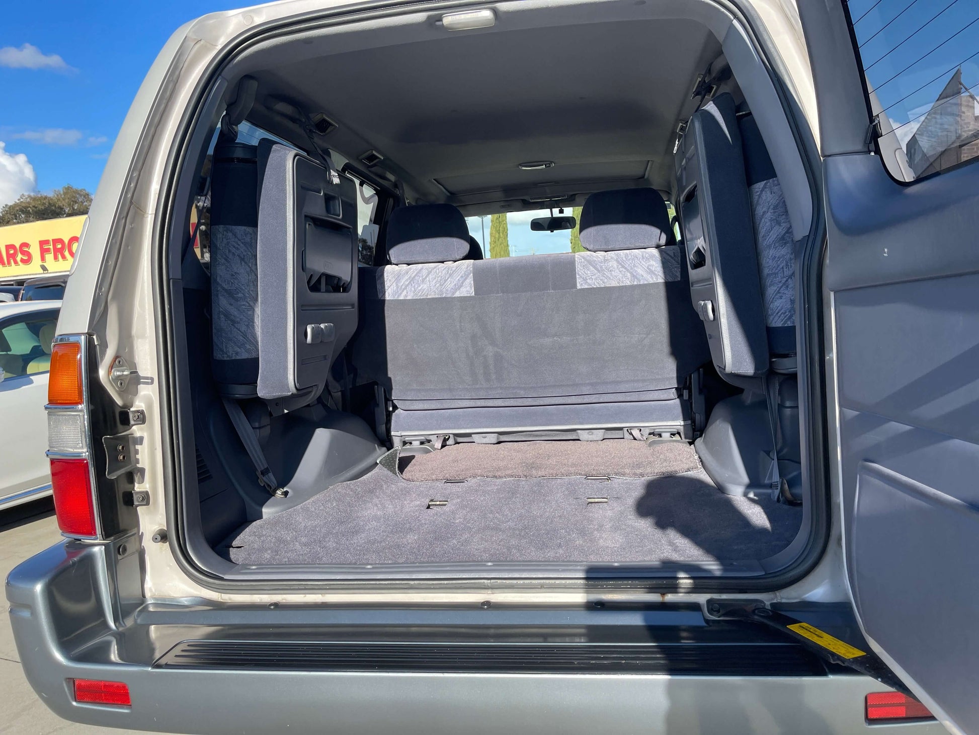 Interior view of 1996 Toyota Land Cruiser Prado V6 3.4L showing spacious seating and cargo area.