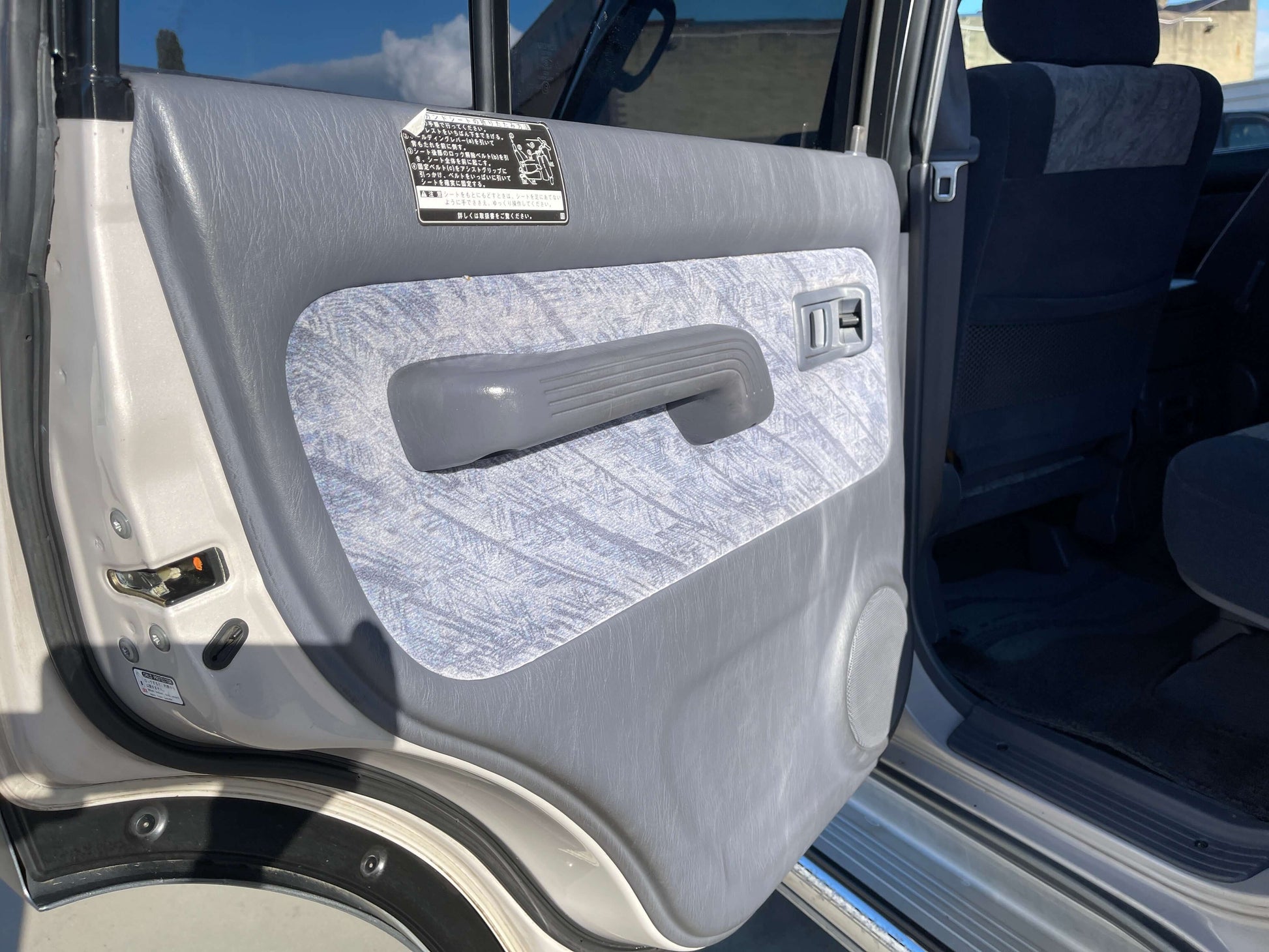 1996 Toyota Land Cruiser Prado V6 3.4L interior door panel with grey and blue design.