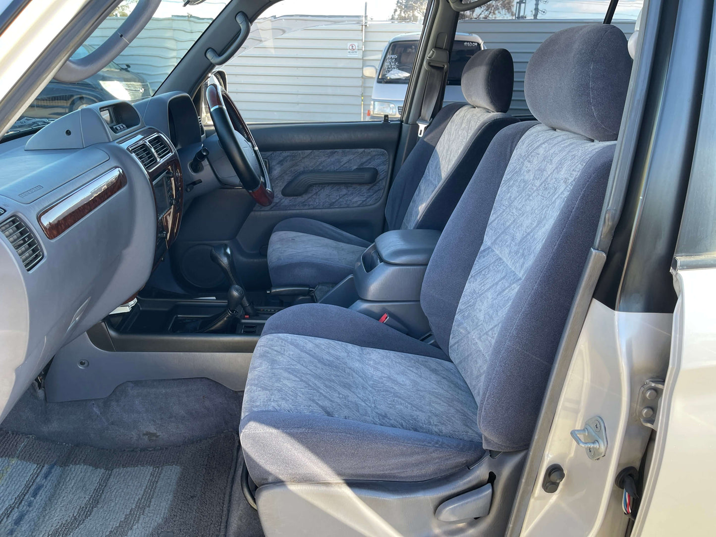Interior view of 1996 Toyota Land Cruiser Prado V6 3.4L showing front seats and dashboard.