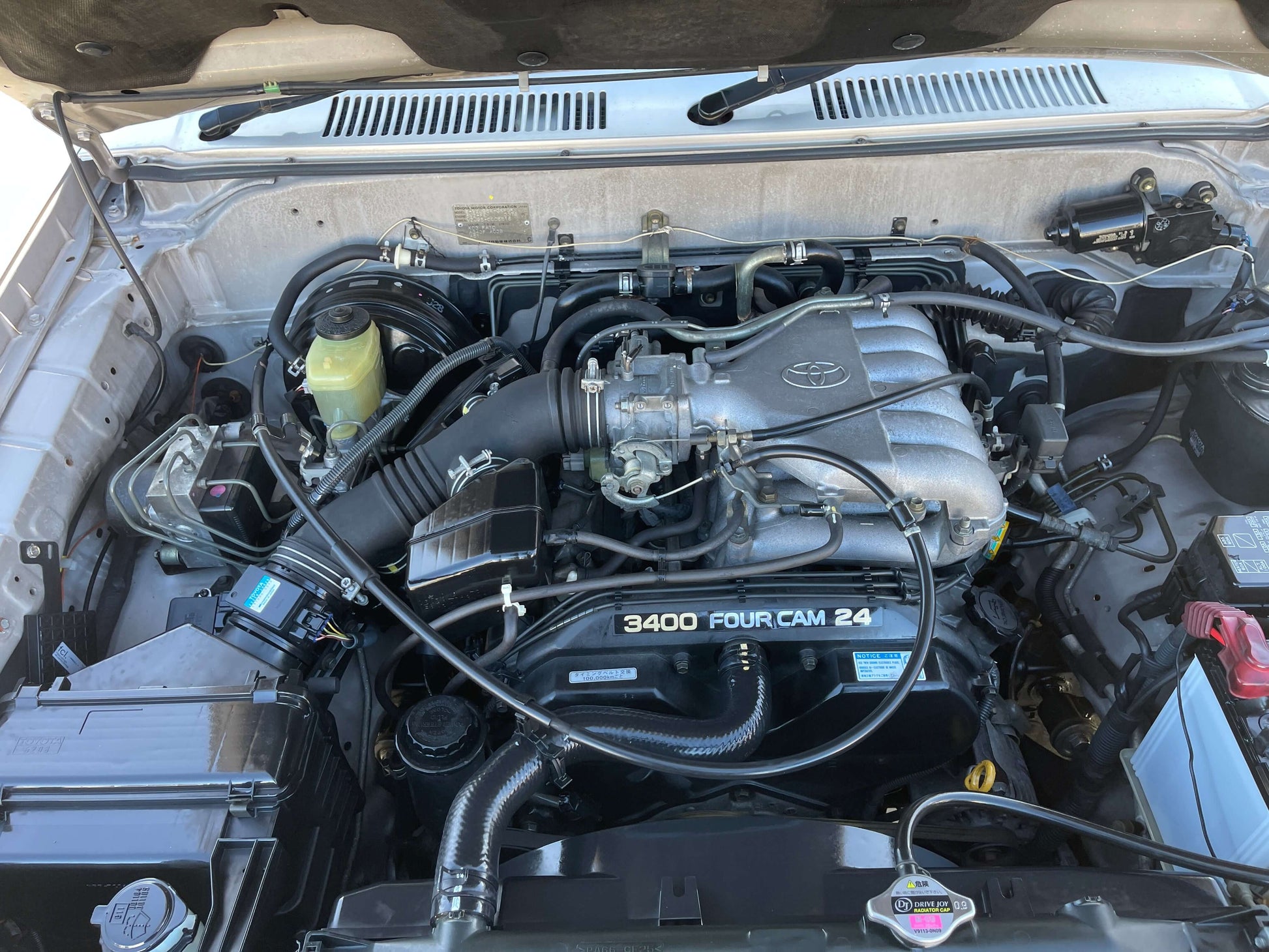 Engine compartment of a 1996 Toyota Land Cruiser Prado V6 3.4L showing the 3400 Four Cam 24 engine.