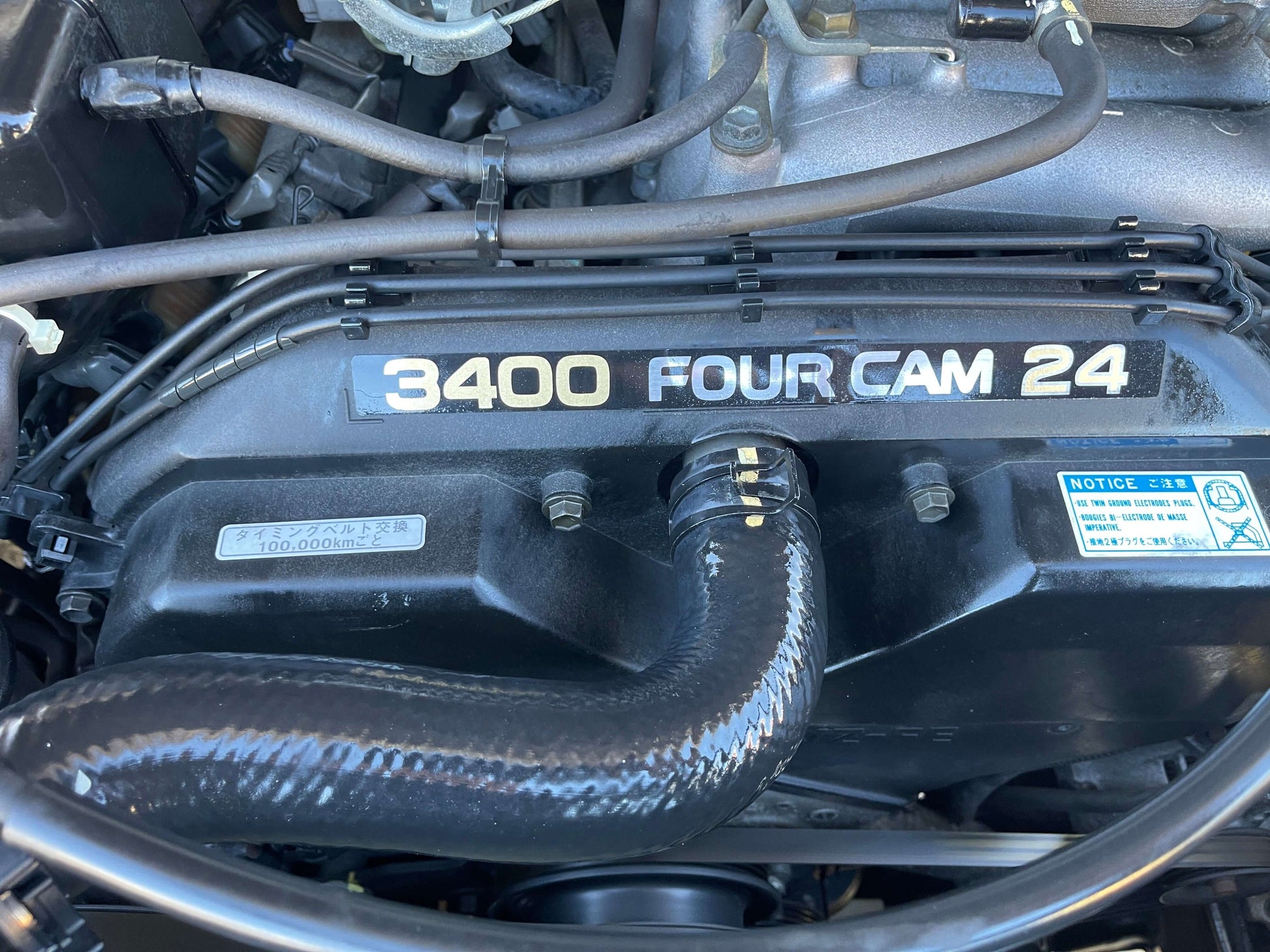 Engine compartment of 1996 Toyota Land Cruiser Prado V6 3.4L showing 3400 Four Cam 24 details.