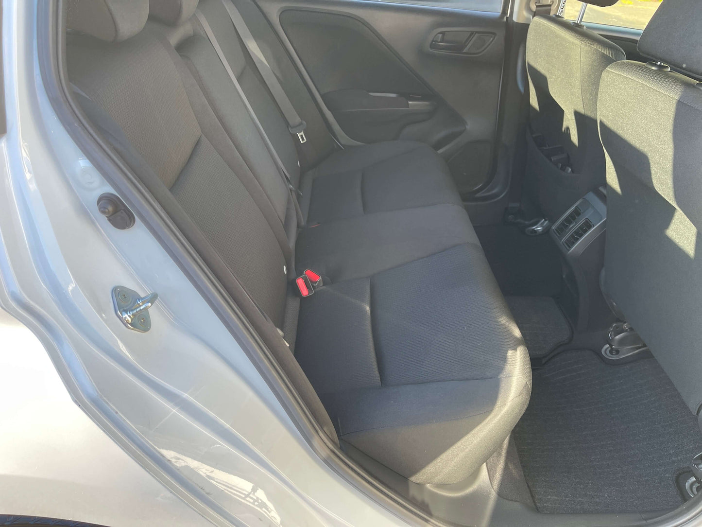Interior view of the back seat in a 2019 Honda Grace 1.5 Hybrid LX Sedan, showcasing spacious seating for five.
