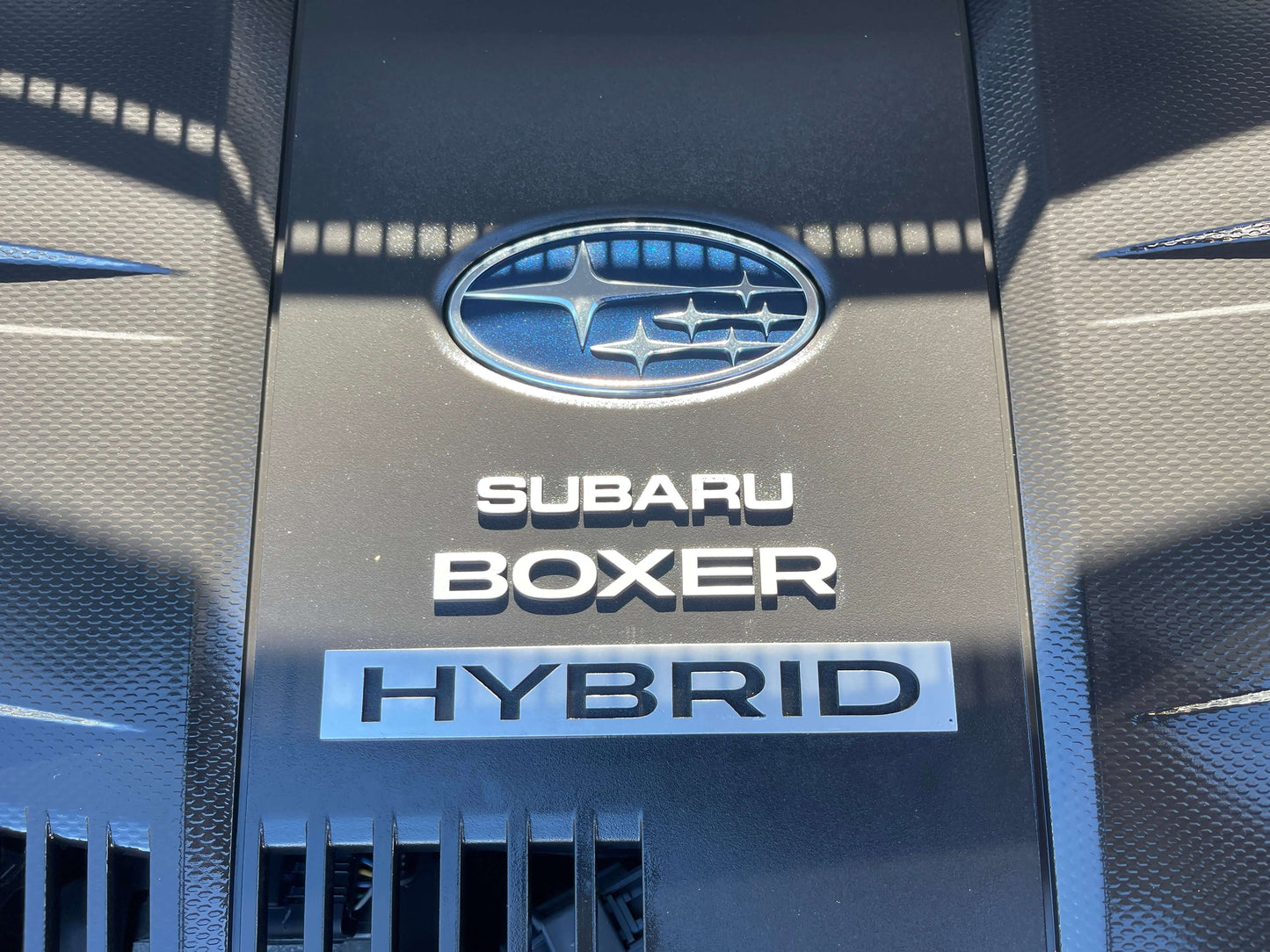 Subaru Boxer engine cover featuring HYBRID emblem, part of the 2014 Subaru XV Hybrid 2.0i-L EyeSight 4WD.