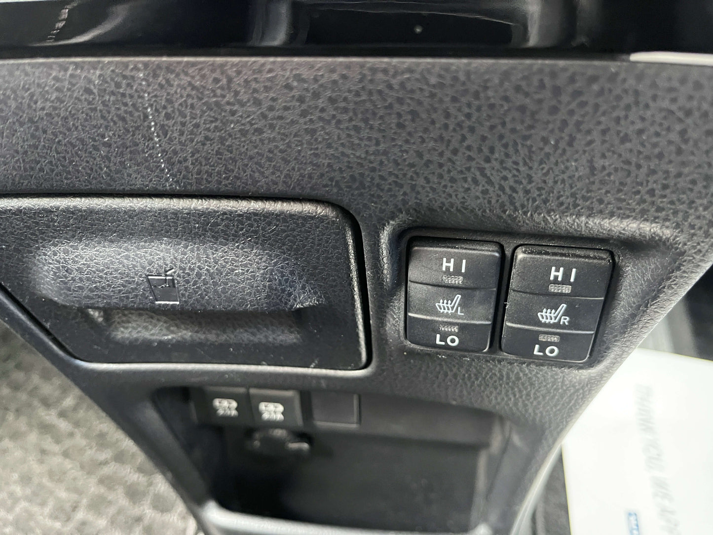 Interior shot of 2018 Toyota Noah 1.8L Hybrid showing seat heater controls, including high and low settings.