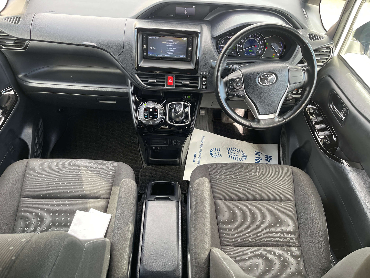 Interior view of a 2018 Toyota Noah 1.8L Hybrid G Edition, showing seating and dashboard features.