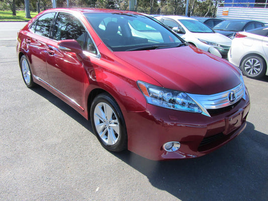 2010 Lexus HS250H 2.4L Hybrid Luxury Sedan in red parked outdoors, showcasing its elegant design and features.