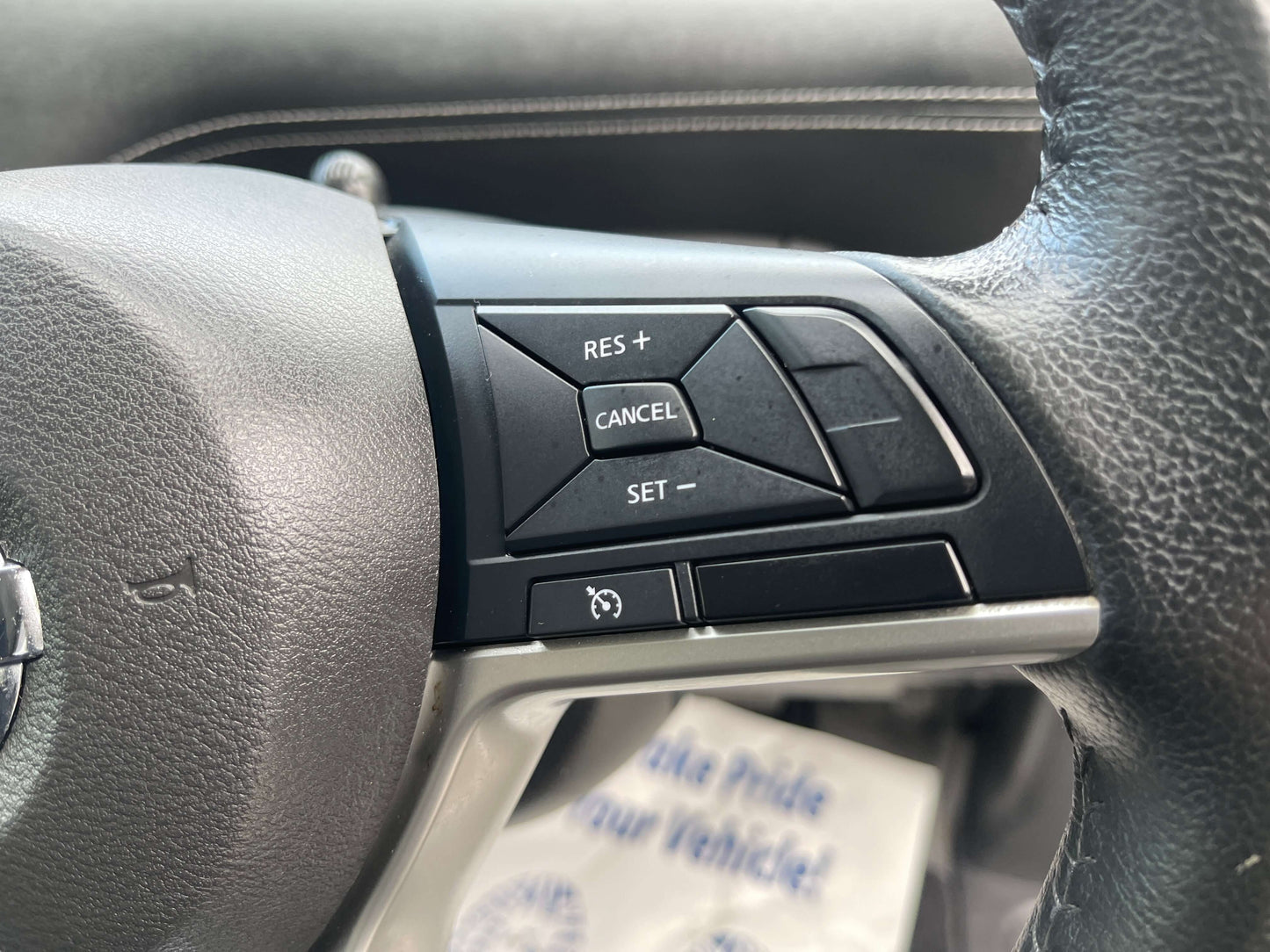 Close-up of the 2016 Nissan Serena steering wheel buttons including RES +, CANCEL, and SET controls.