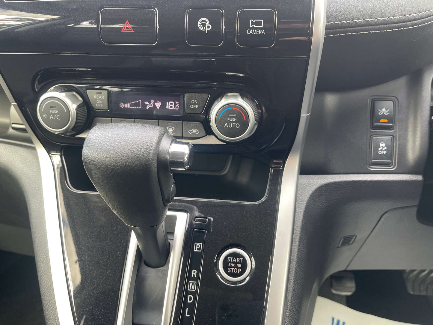 Interior dashboard of a 2016 Nissan Serena showing controls and gear shift.