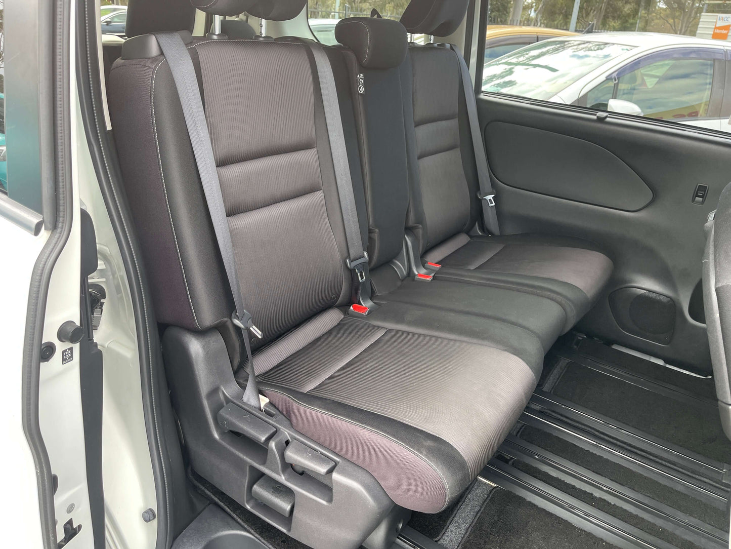 Interior view of the rear seating in a 2016 Nissan Serena, featuring comfortable seating for 8 passengers.