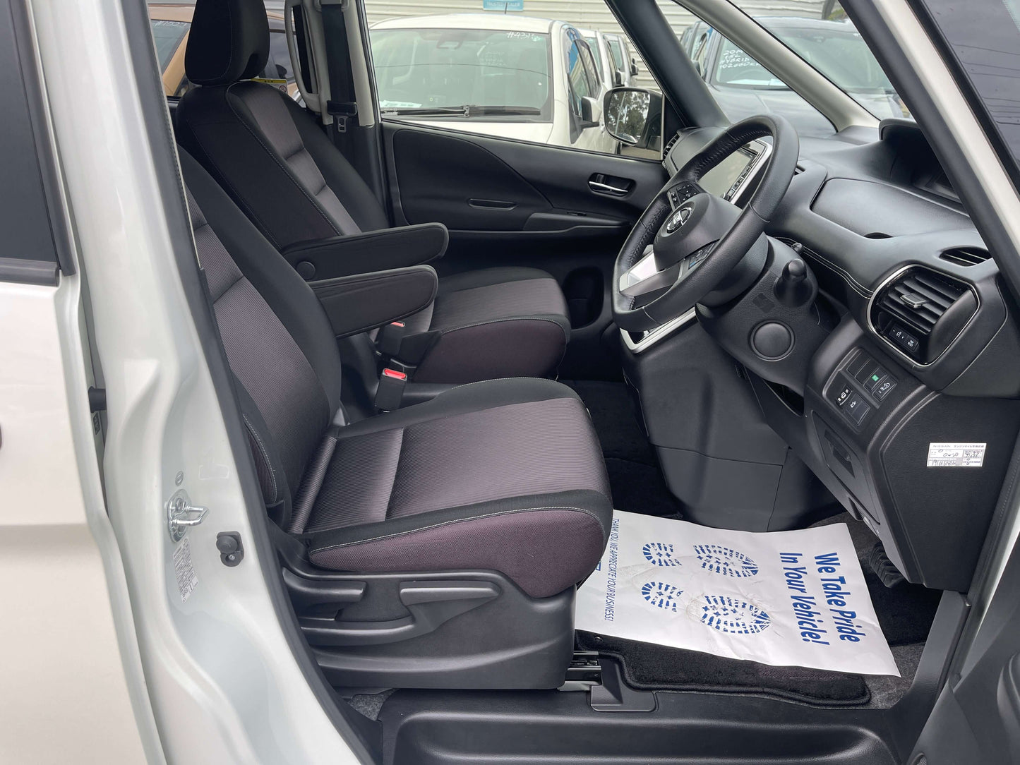 Interior view of 2016 Nissan Serena with front seats and dashboard, showcasing comfort and layout.