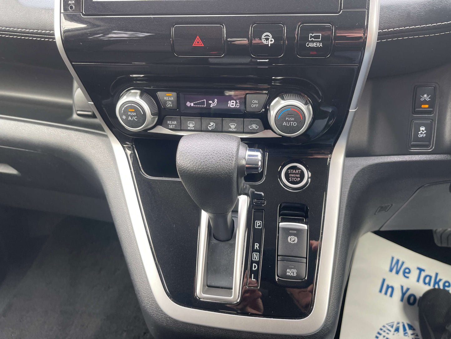 Interior controls of a 2016 Nissan Serena 2.0L 4WD S-Hybrid ProPilot Edition with gear shift and climate settings.