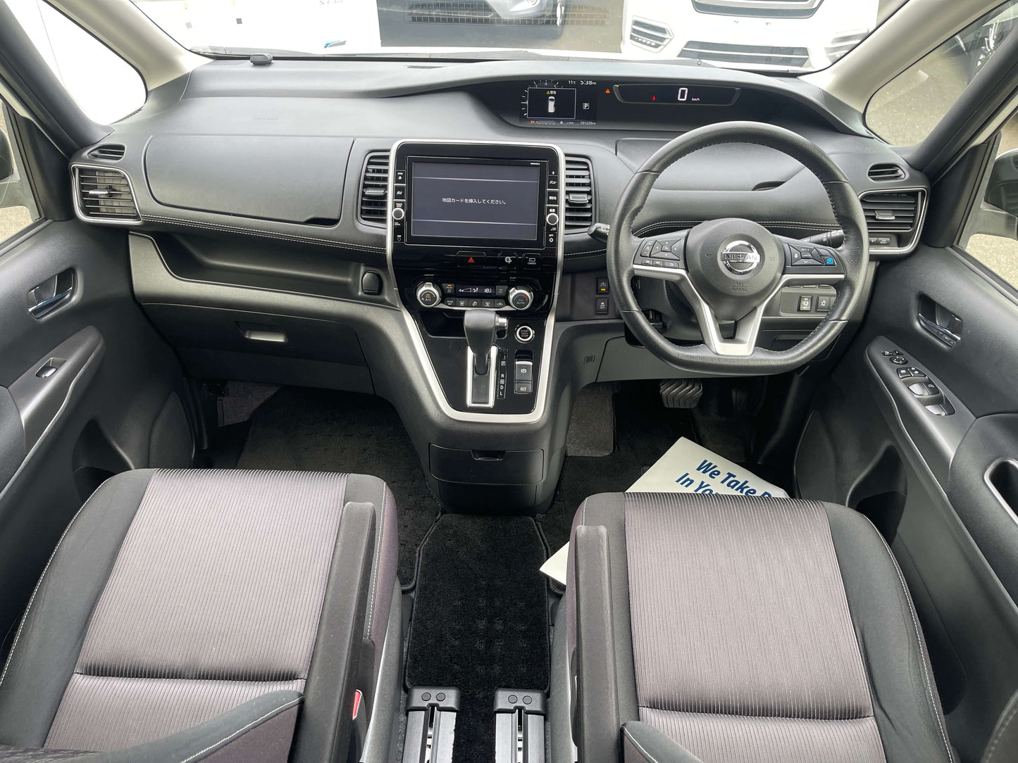Interior view of the 2016 Nissan Serena showing dashboard and seating arrangement, 8 seats layout.
