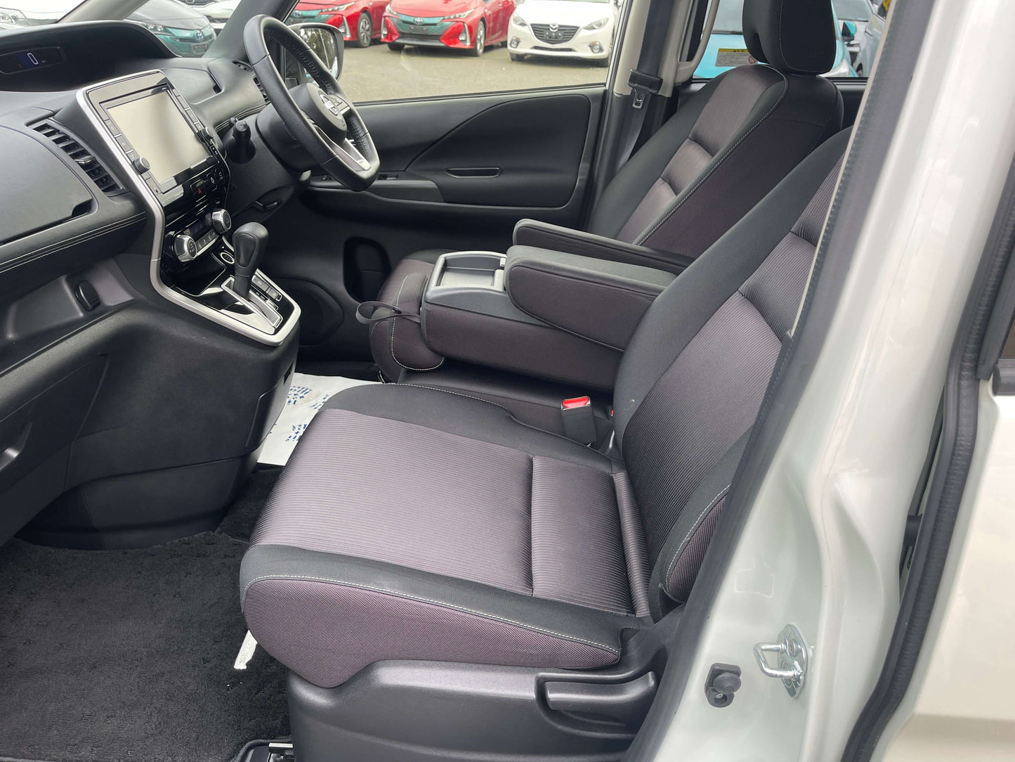 Interior view of 2016 Nissan Serena with spacious seats and modern dashboard design.