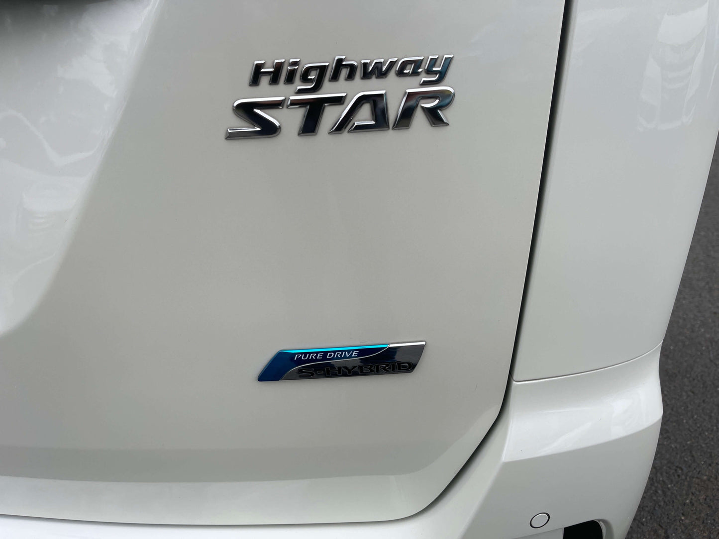 Close-up of the 2016 Nissan Serena Highway Star badge and Pure Drive emblem on rear of vehicle.