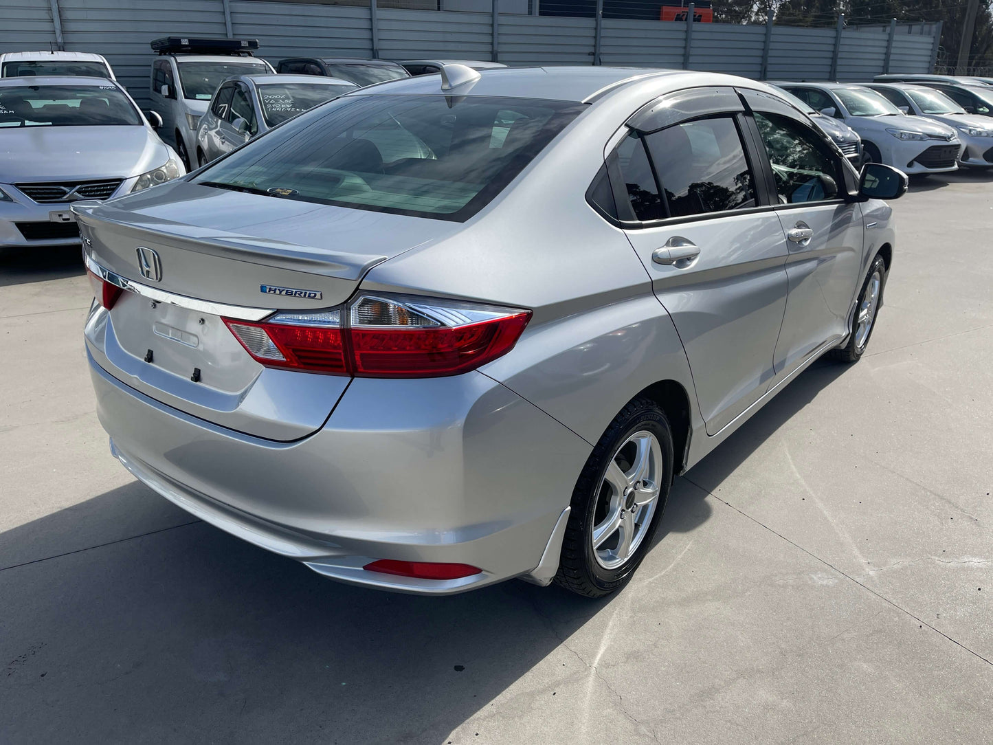 2015 Honda Grace 1.5 Hybrid DX Sedan rear view in silver color at a dealership.