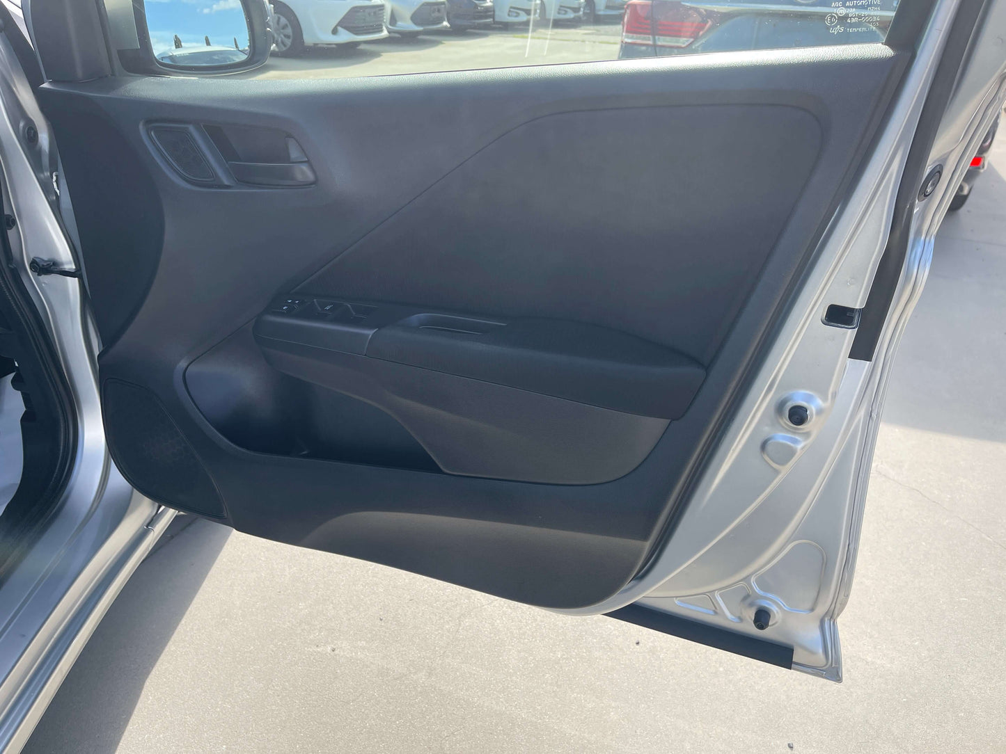 Interior door panel of a 2015 Honda Grace 1.5 Hybrid DX Sedan, showcasing sleek design and controls.
