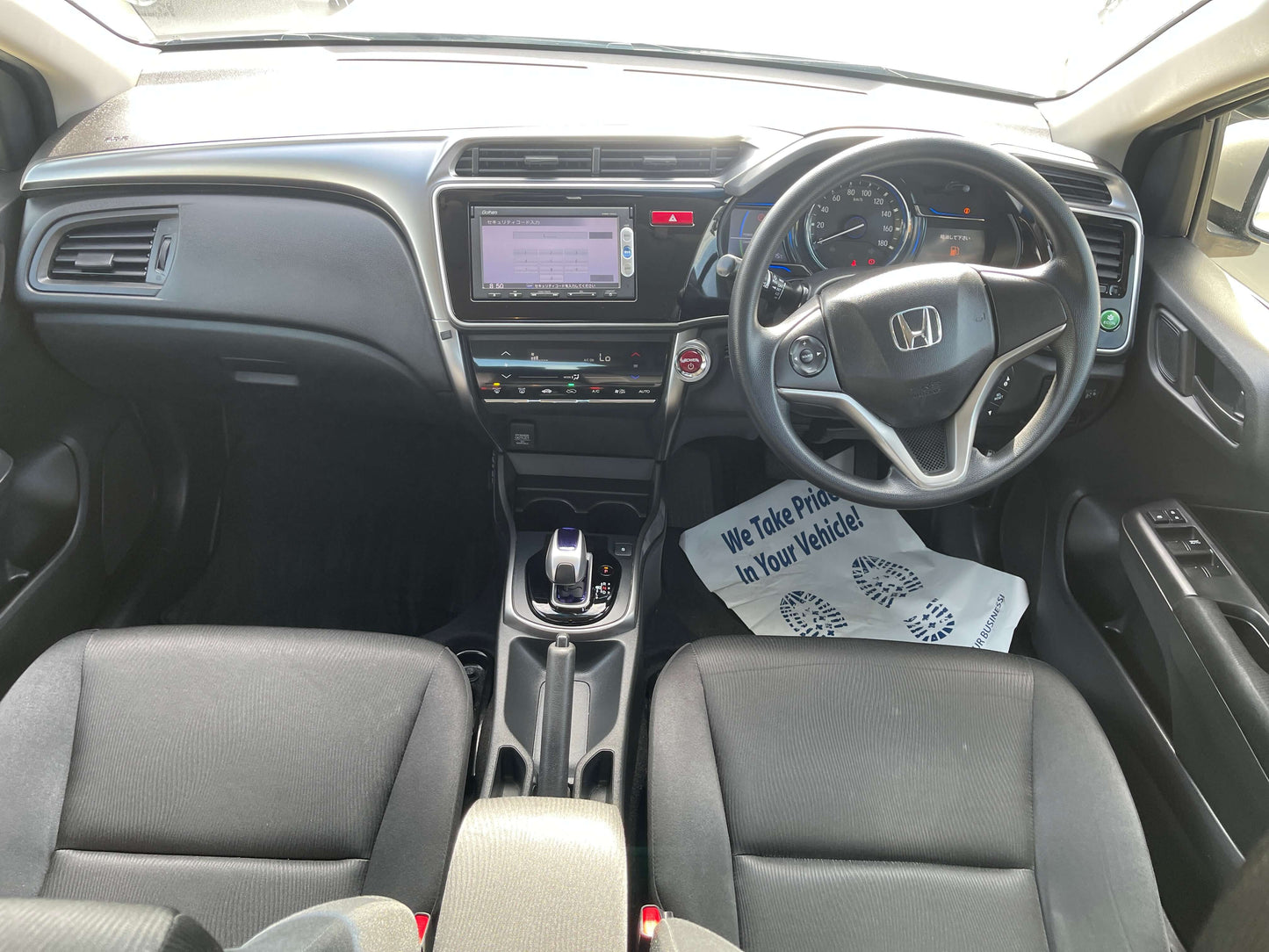 Interior view of the 2015 Honda Grace 1.5 Hybrid DX Sedan featuring a modern dashboard and comfortable seating.