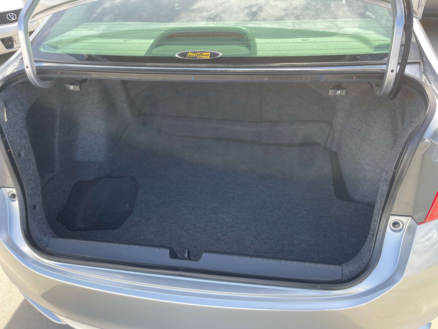 Spacious trunk of a 2015 Honda Grace 1.5 Hybrid DX Sedan, showcasing ample storage for 5-seater road trips.