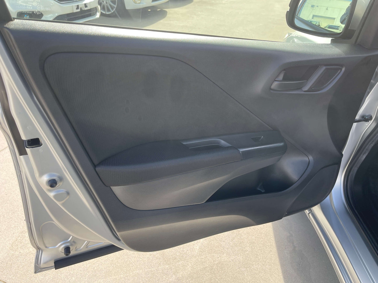 Interior view of the door panel of a 2015 Honda Grace 1.5 Hybrid DX Sedan, showcasing sleek design and features.