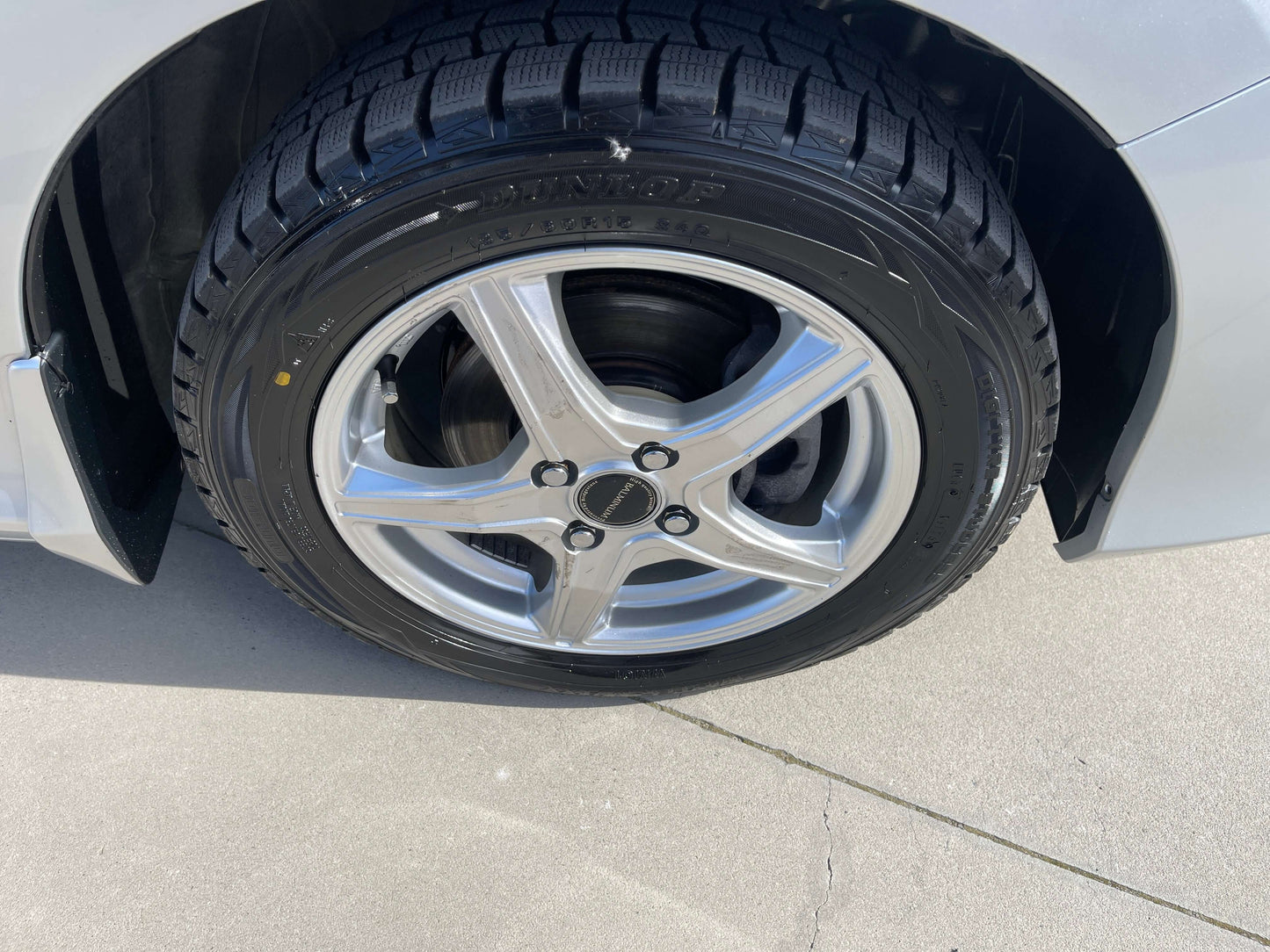 Close-up of a 2015 Honda Grace 1.5 Hybrid wheel with silver alloy rim and quality tire tread.