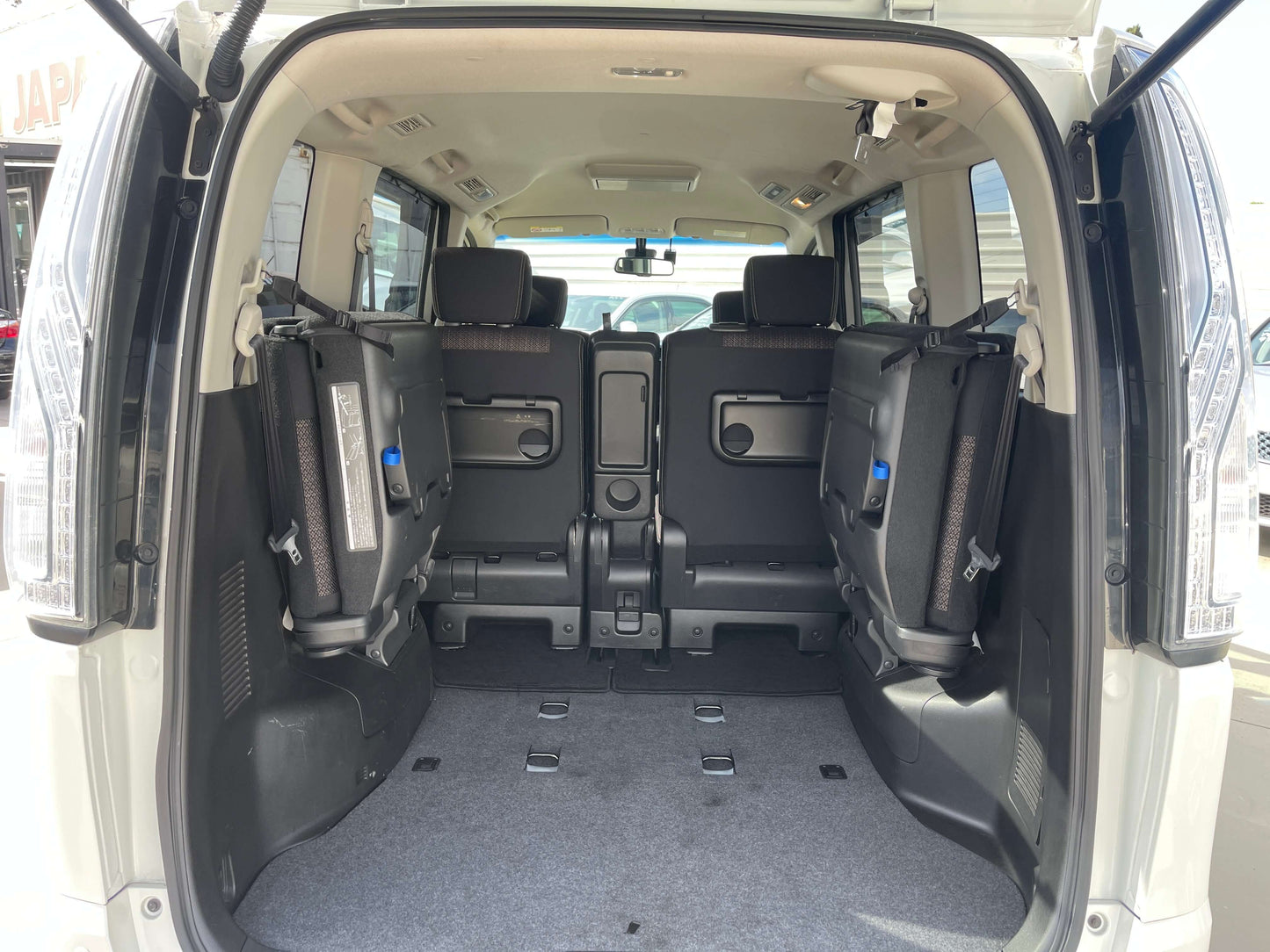 2016 Nissan Serena spacious interior showing rear seats folded down for ample cargo space.