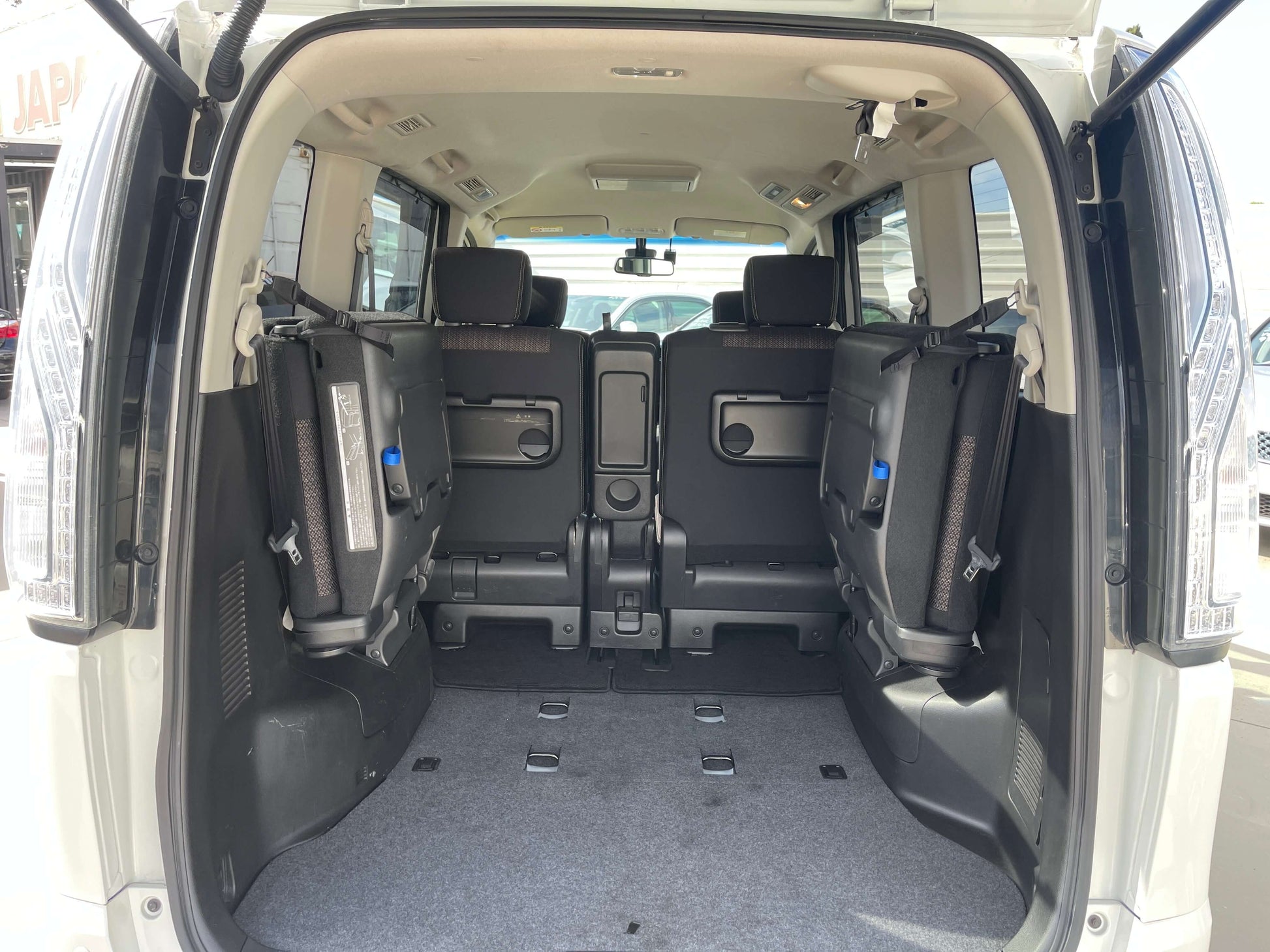 2016 Nissan Serena spacious interior showing rear seats folded down for ample cargo space.