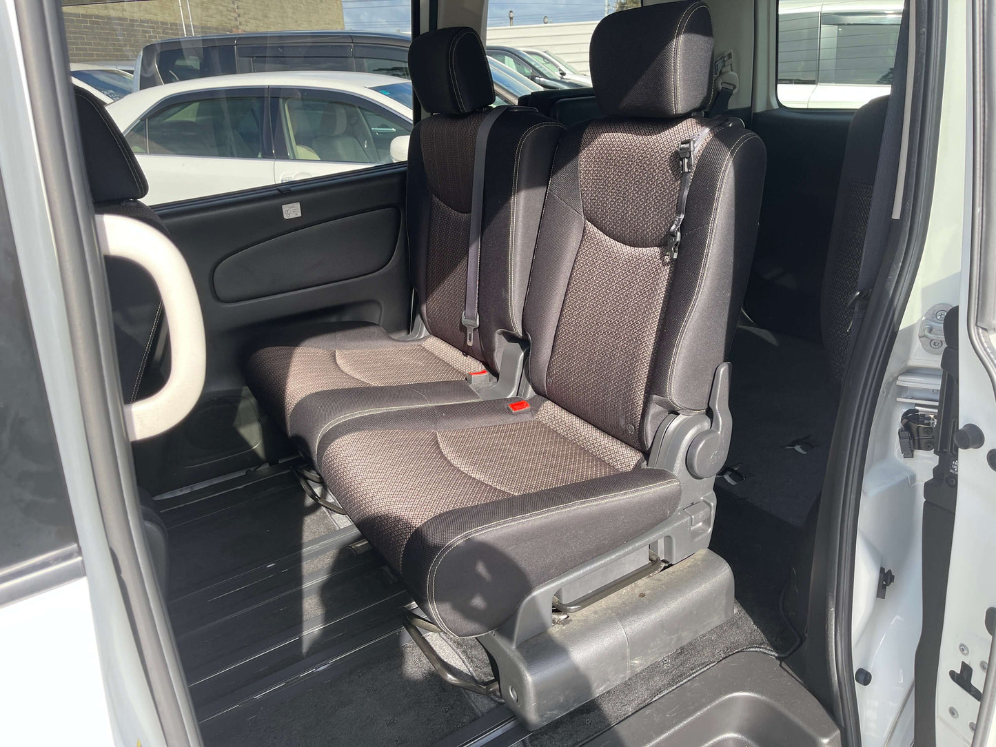 Interior of the 2016 Nissan Serena showing spacious 8-seater rear seating with comfortable fabric upholstery.