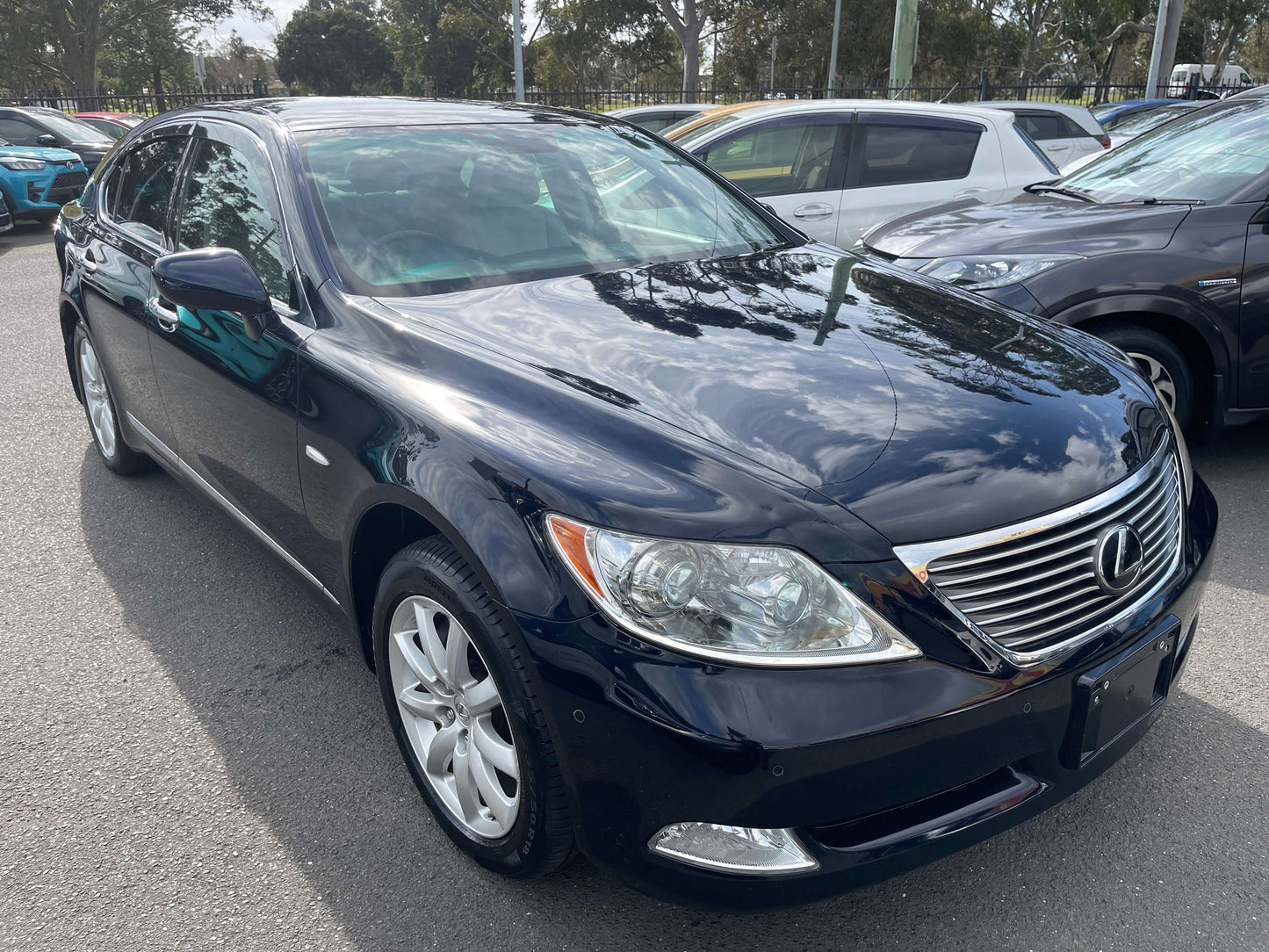 2006 Lexus LS460 V8 4.6L I Package Premium Luxury Sedan in dark blue parked outside.