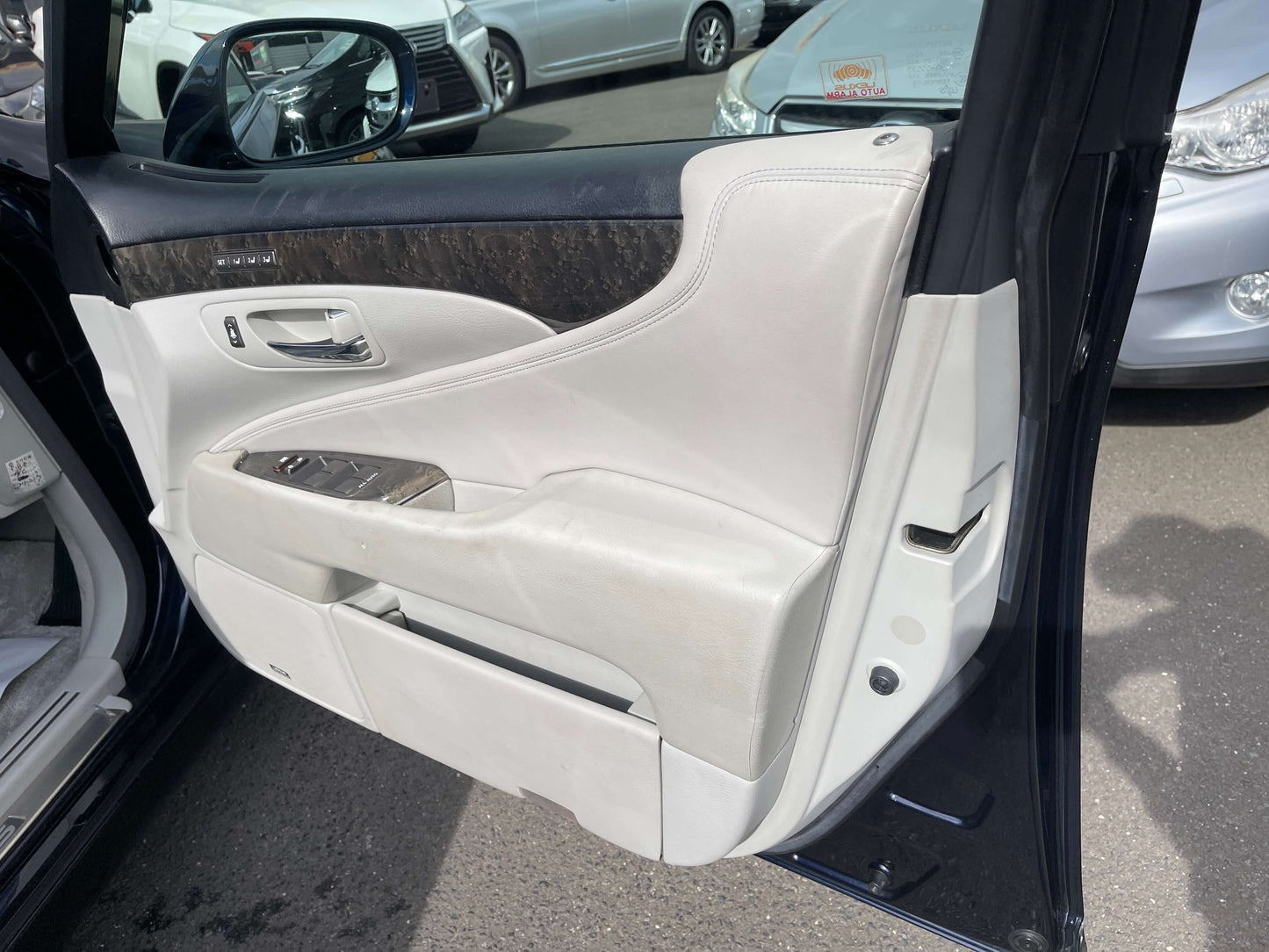Interior view of the 2006 Lexus LS460 V8 4.6L door showing premium leather and wood trim.