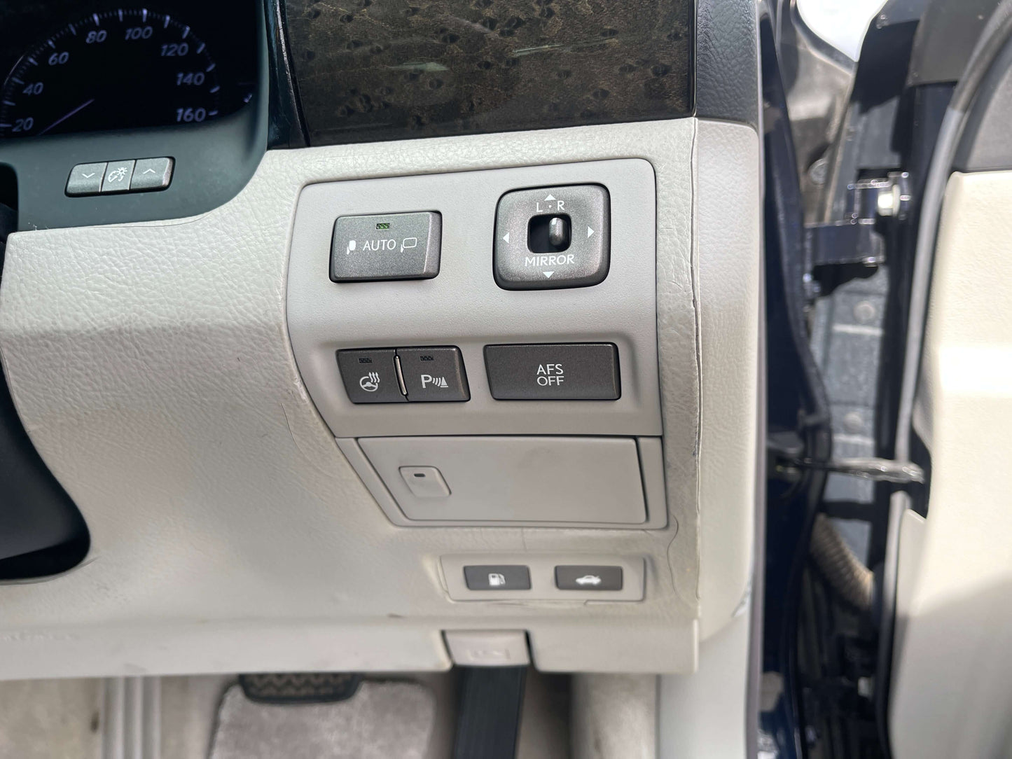 Close-up of controls in 2006 Lexus LS460 V8 4.6L sedan interior, featuring various buttons and settings.