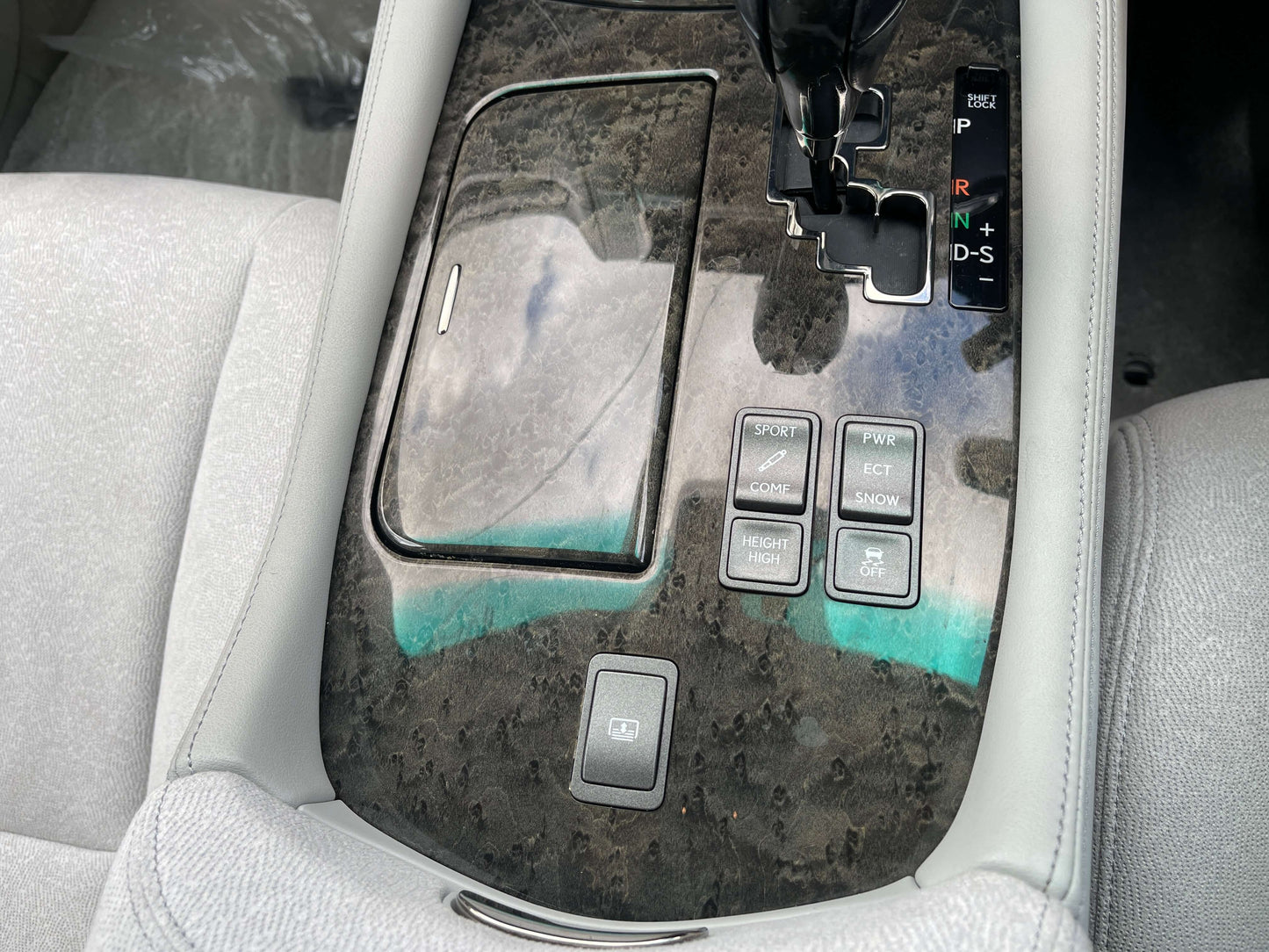 2006 Lexus LS460 V8 4.6L interior console features with buttons and gear shift.