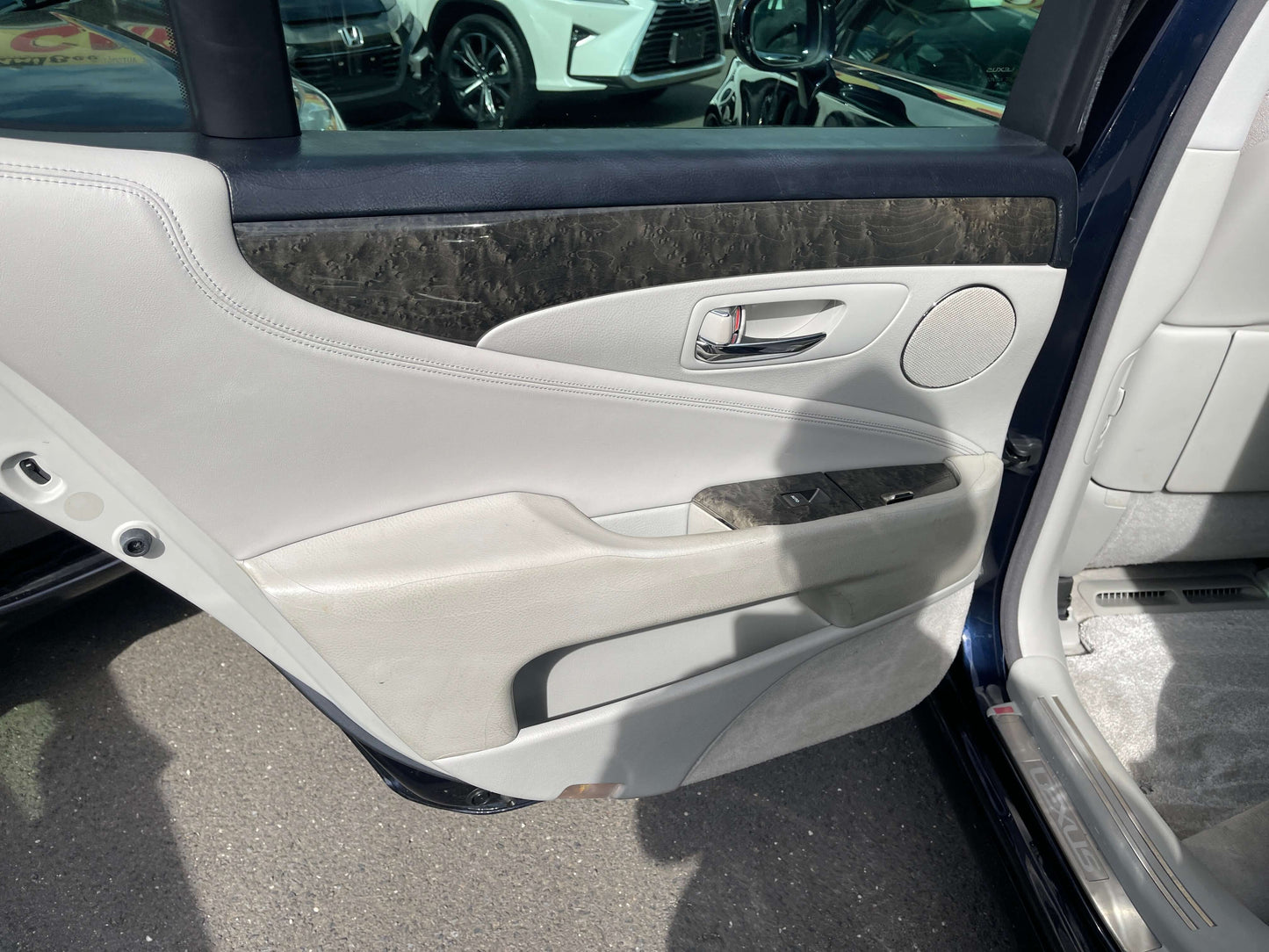 Interior view of the door panel of a 2006 Lexus LS460 V8 4.6L Premium Luxury Sedan, highlighting luxury finishes.