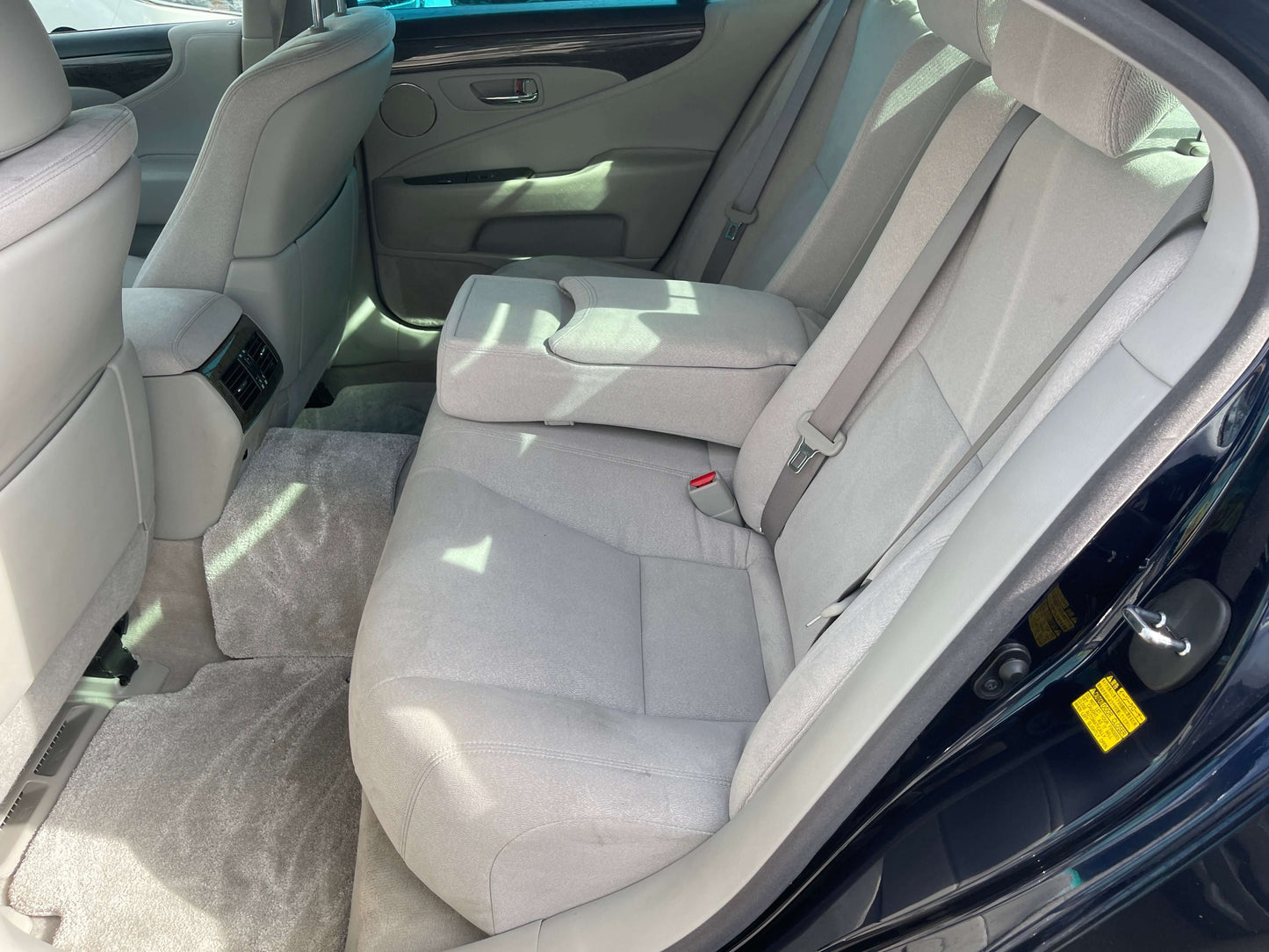 Interior view of the back seat of a 2006 Lexus LS460 V8 4.6L Premium Luxury Sedan, showcasing spacious and comfortable seating.