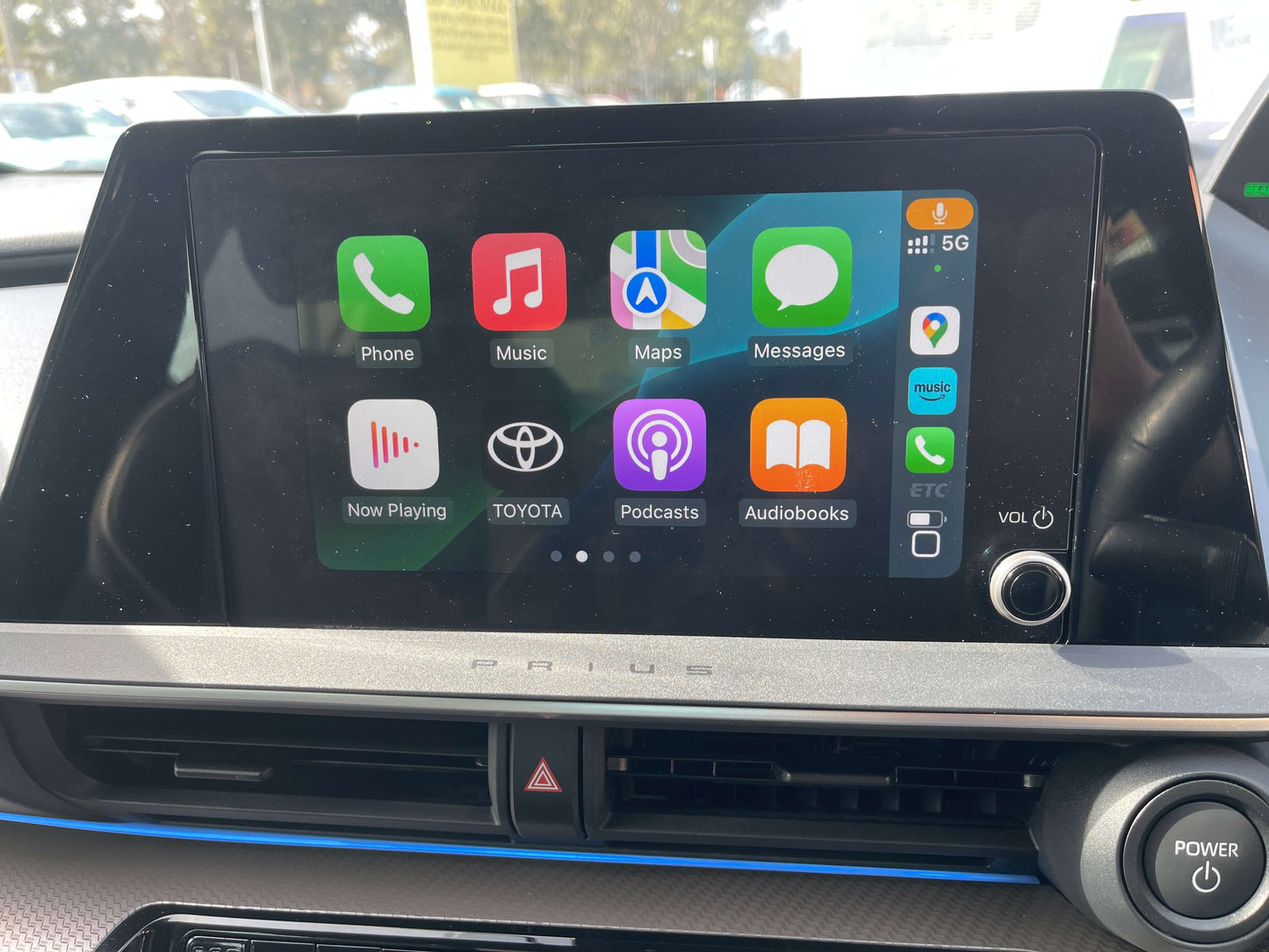 Interior screen of a 2024 Toyota Prius Hybrid displaying apps like Phone, Music, and Maps.