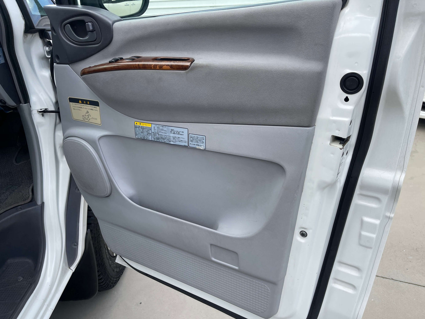 Interior door panel of a 2006 Mitsubishi Delica showing features and materials.