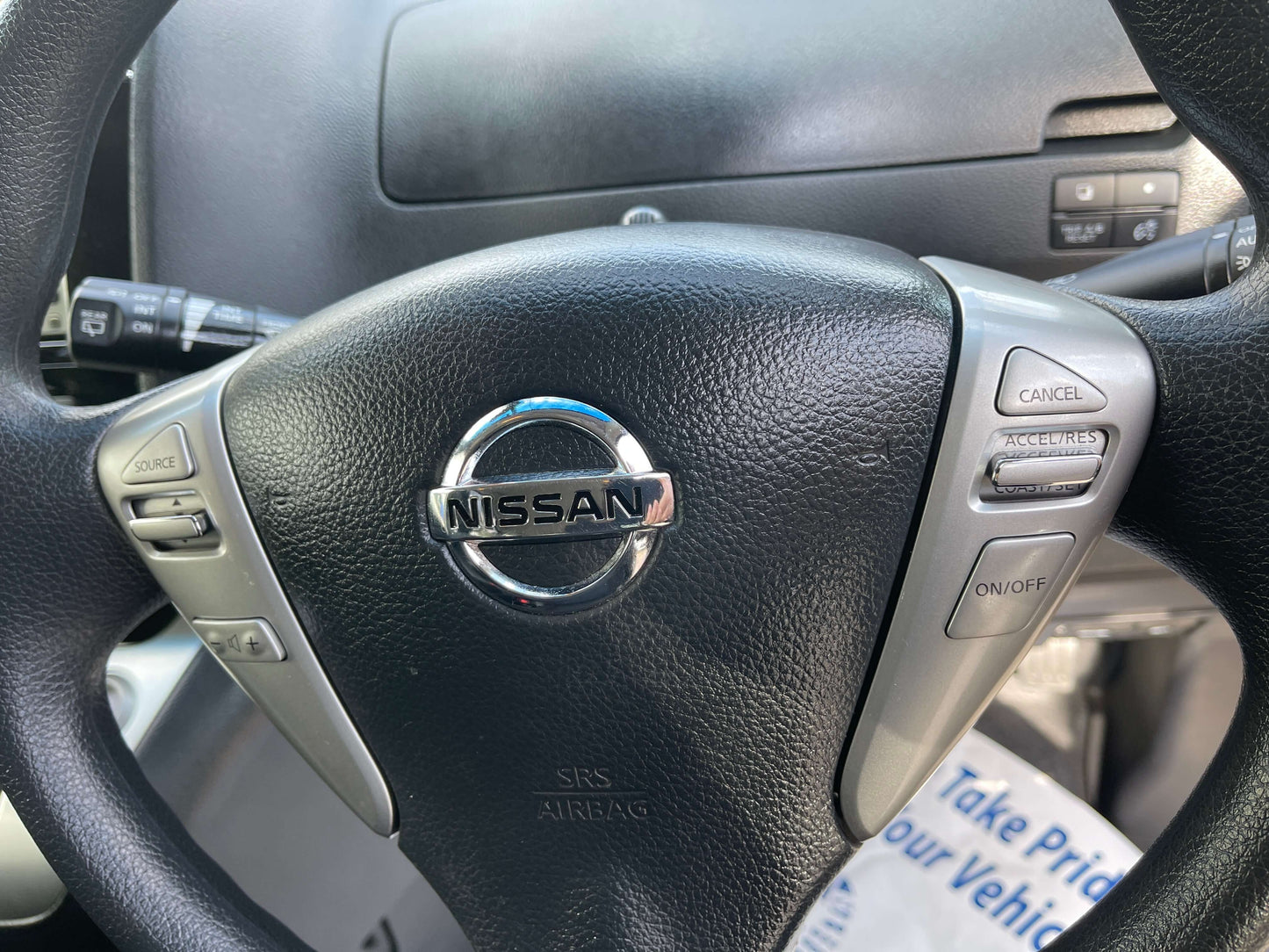 2016 Nissan Serena steering wheel with control buttons and Nissan emblem