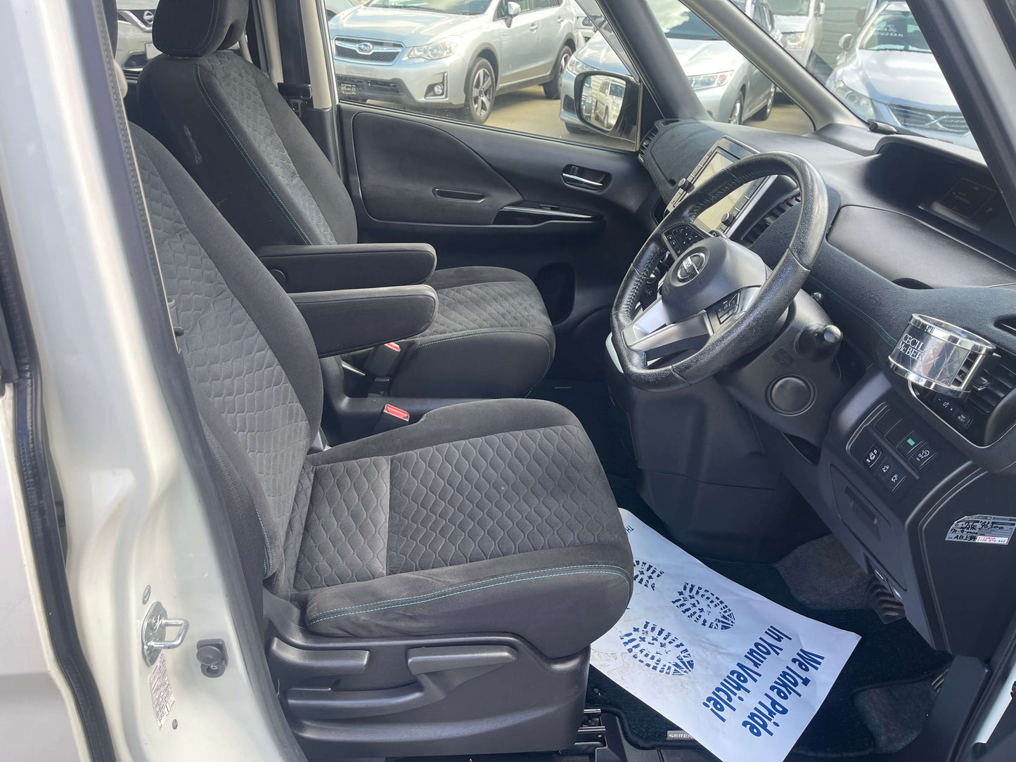 Interior view of 2016 Nissan Serena 2.0L S-Hybrid Rider Autech Edition with black seats and dashboard layout.