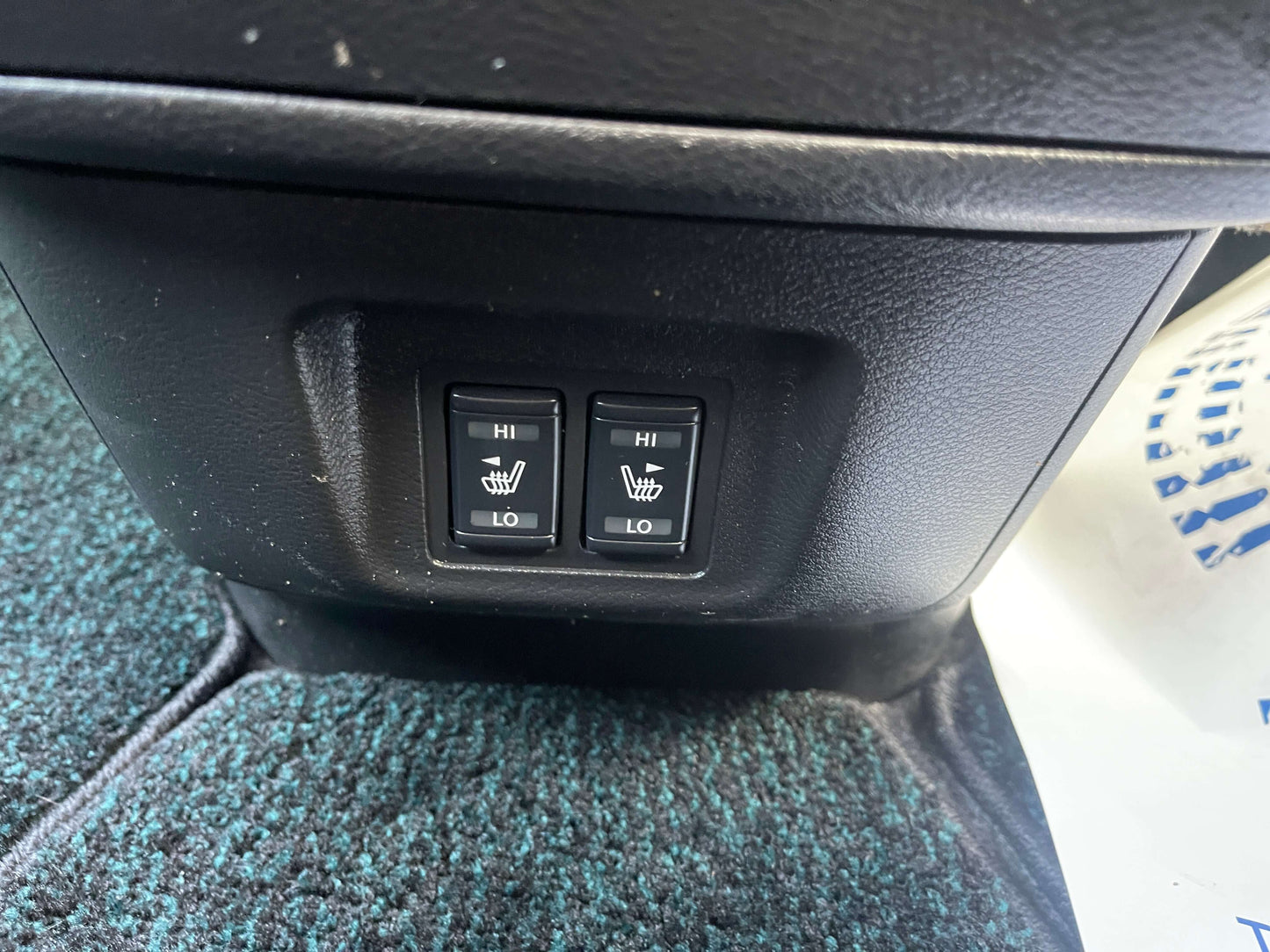 Heated seat controls in 2016 Nissan Serena with high and low settings.