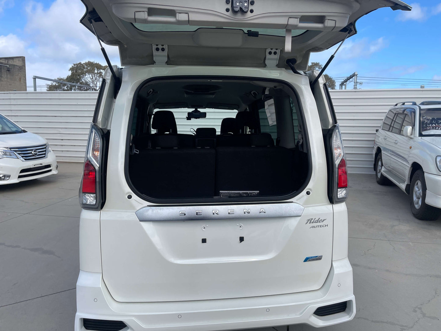 Rear view of the 2016 Nissan Serena 2.0L S-Hybrid Rider Autech Edition showcasing spacious trunk area.