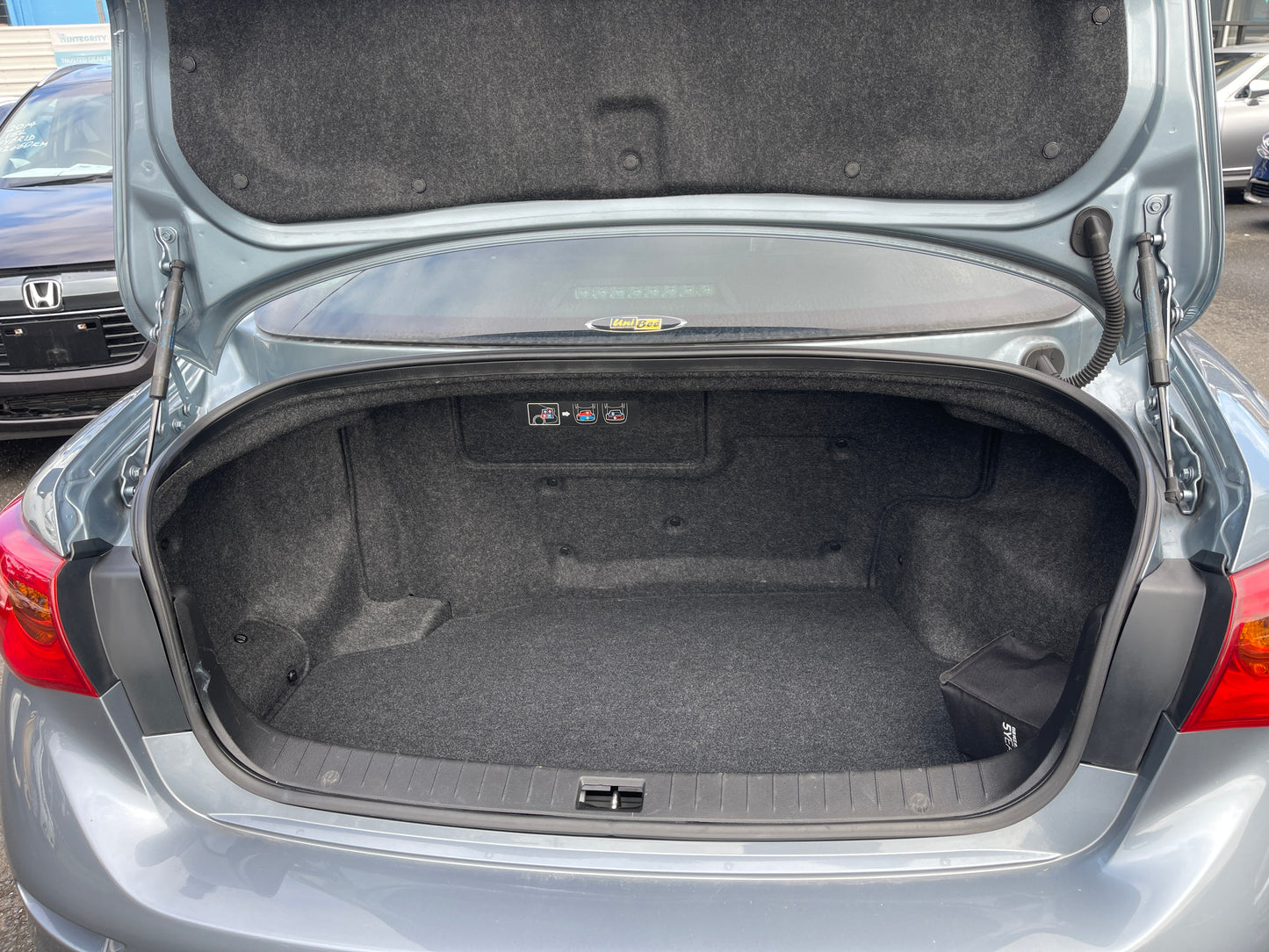 2016 Nissan Skyline V6 3.5L Hybrid trunk space with ample storage capacity and clean interior.