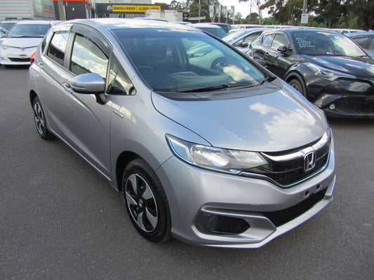2017 Honda Fit 1.5L Hybrid in silver, showcasing its compact design and fuel-efficient features for city driving.