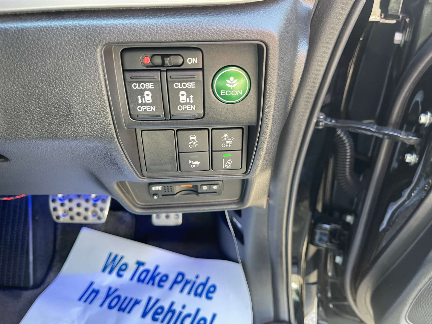 Control panel of the 2016 Honda Odyssey 2.0 Hybrid featuring buttons for door control and ECO mode.