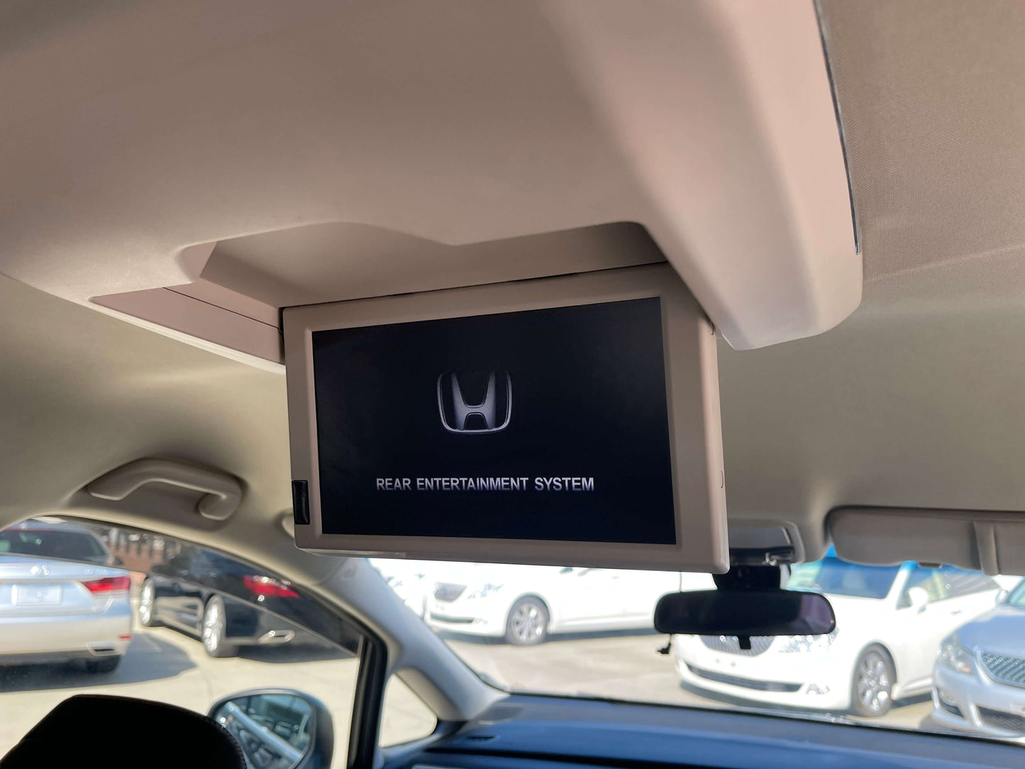 2016 Honda Odyssey 2.0 Hybrid Rear entertainment system display in a Honda vehicle, showing Honda logo and system title.