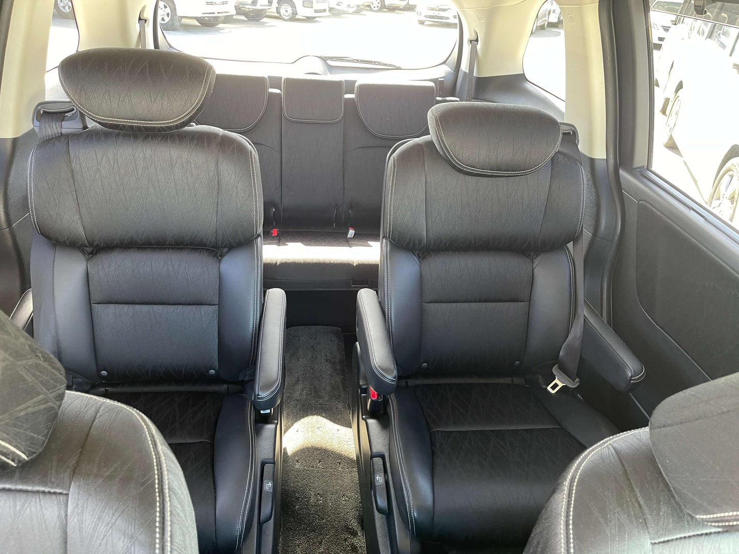 Interior view of the 2016 Honda Odyssey 2.0 Hybrid showcasing luxury black seating for seven passengers.