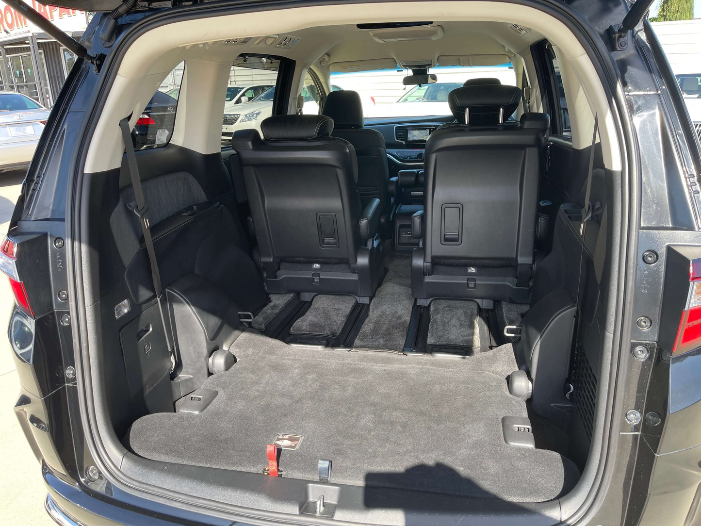 Interior view of the 2016 Honda Odyssey 2.0 Hybrid showing spacious seating area with rear seats folded down.