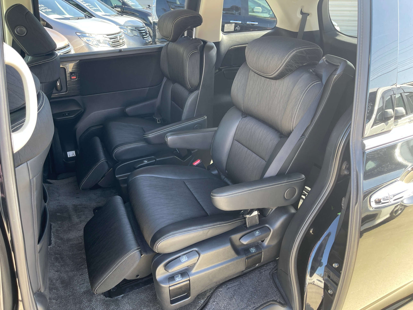 Interior view of 2016 Honda Odyssey 2.0 Hybrid with spacious seating for 7, showcasing comfortable front seats.