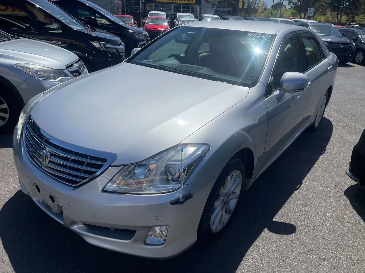 2008 Toyota Crown V6 3.0L Royal Saloon Luxury Sedan in silver parked among other cars.