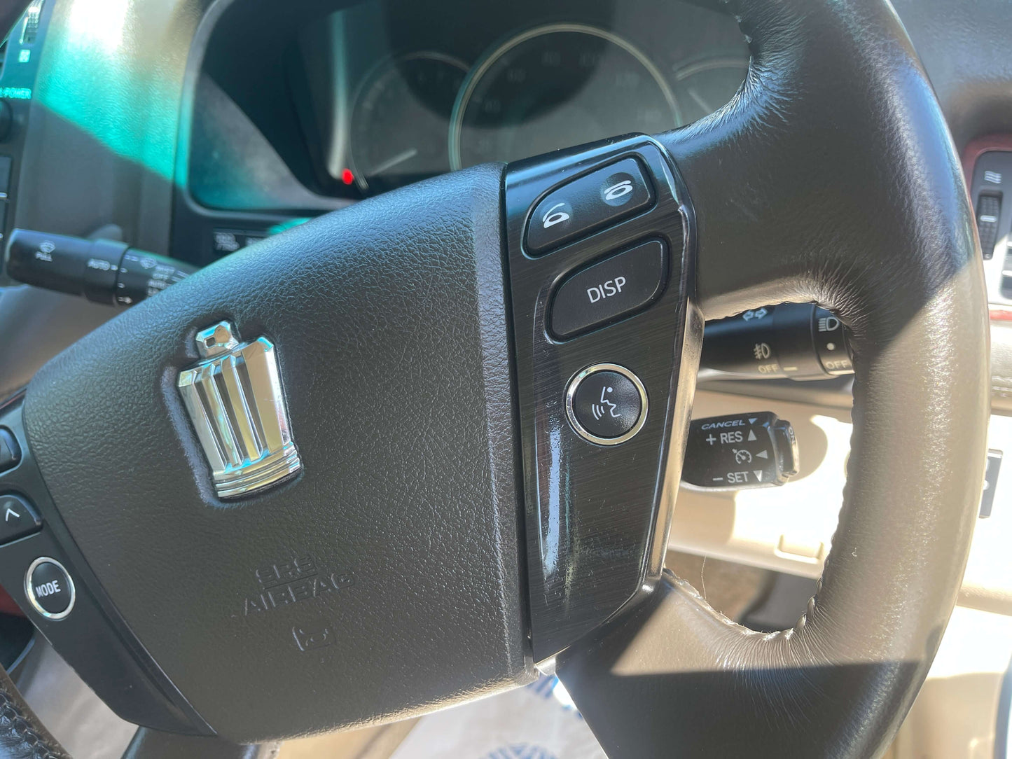 Close-up view of the steering wheel controls in a 2008 Toyota Crown V6 3.0L Royal Saloon Luxury Sedan.